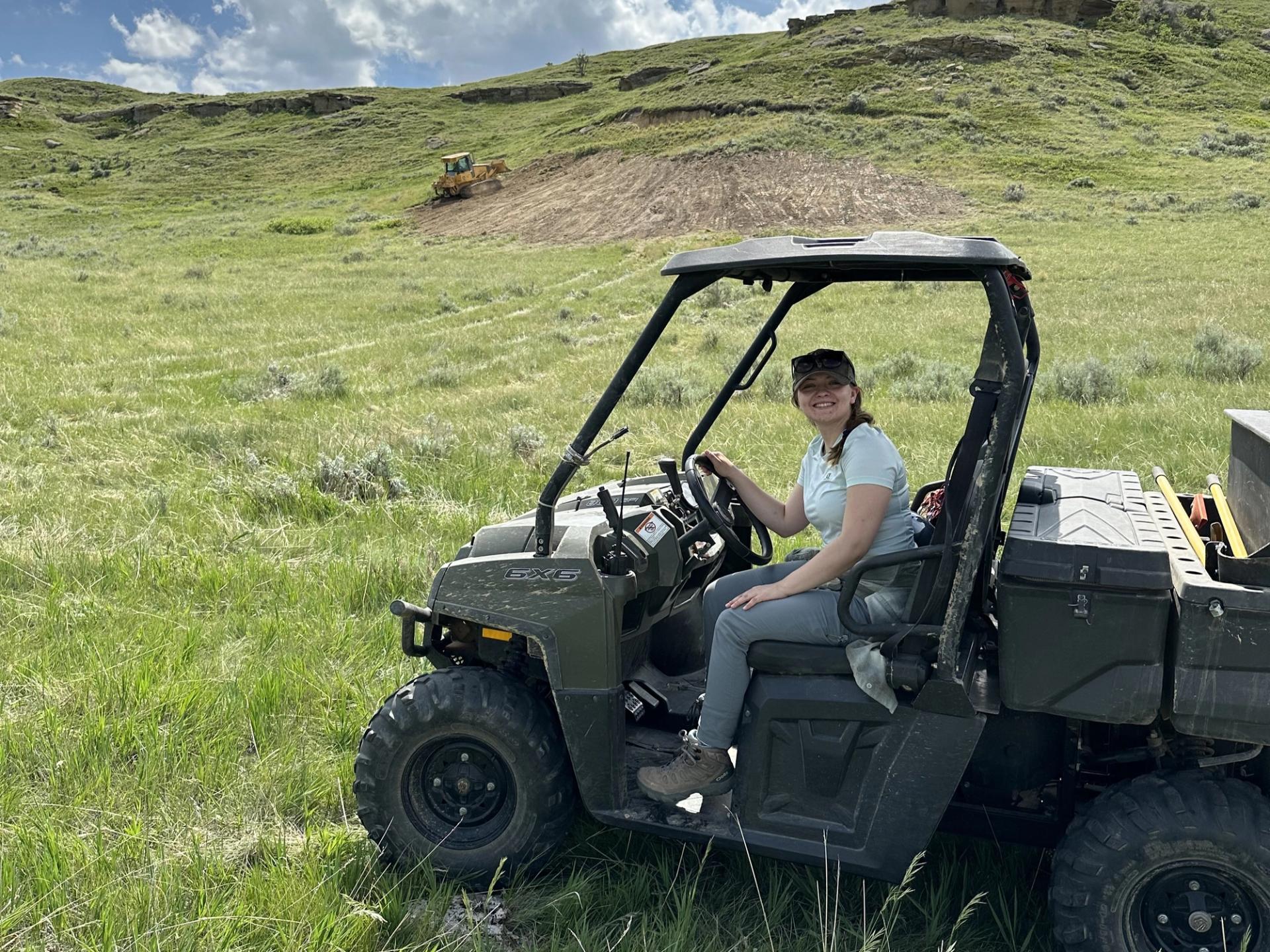 Photo of GeoCorps Participant driving a four wheeler in the field