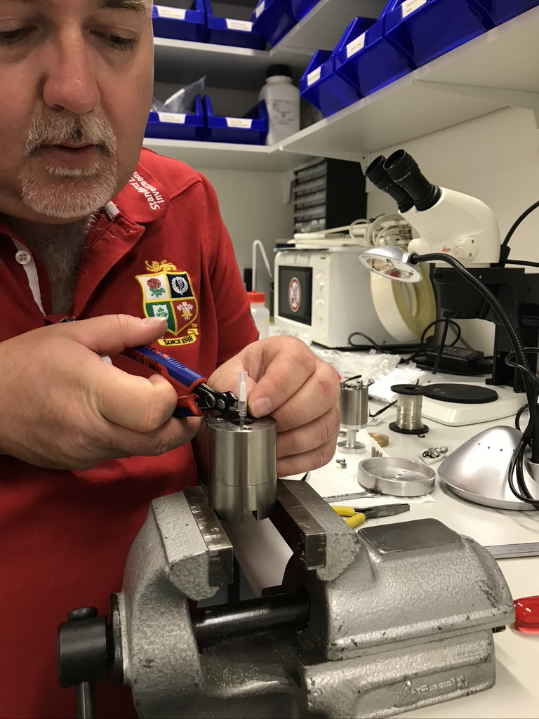 Man handling a gypsum sample in a lab