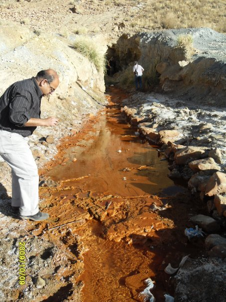 A man inspects a hydrogeological site.