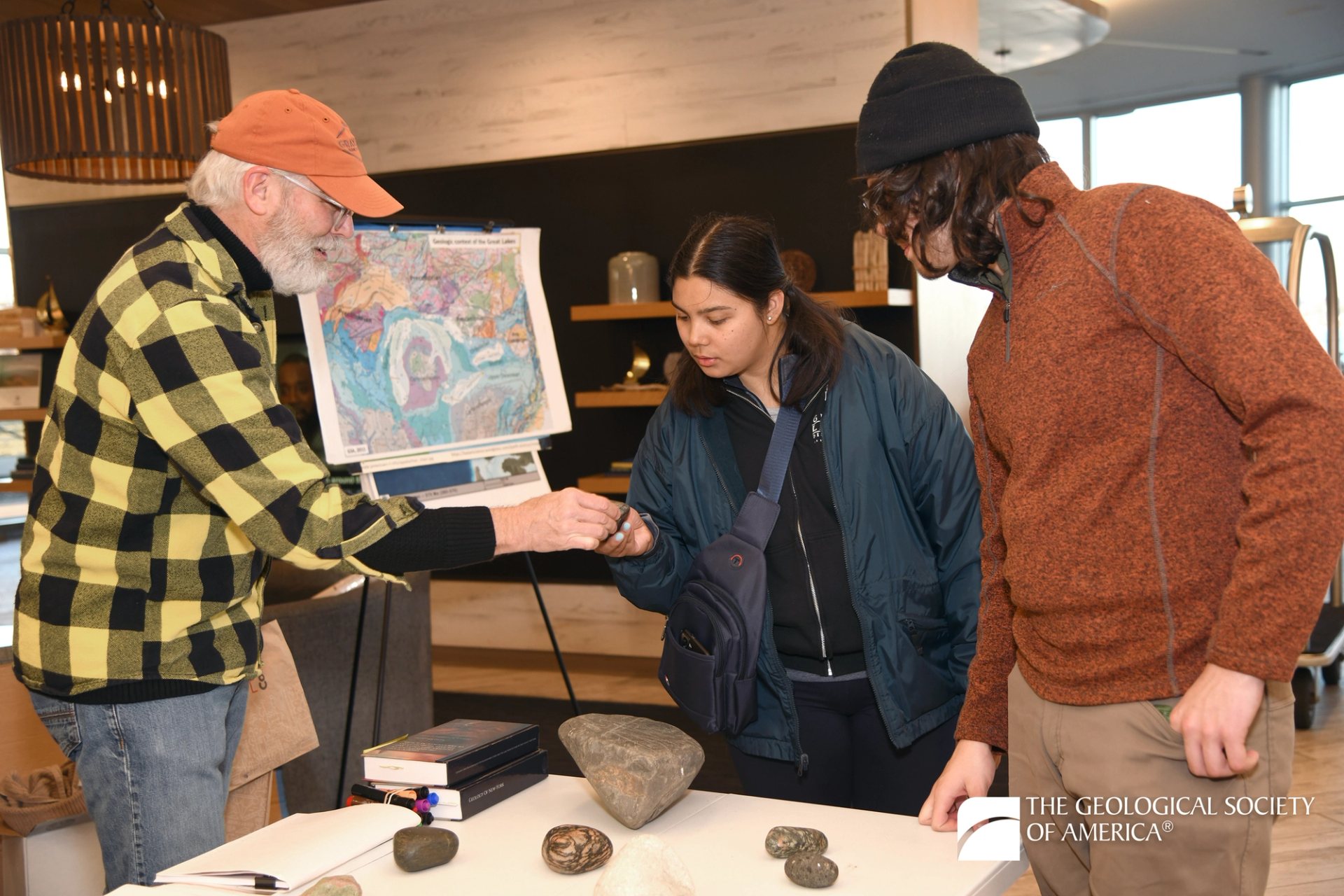 Geologist showing students map and rock samples at GSA event