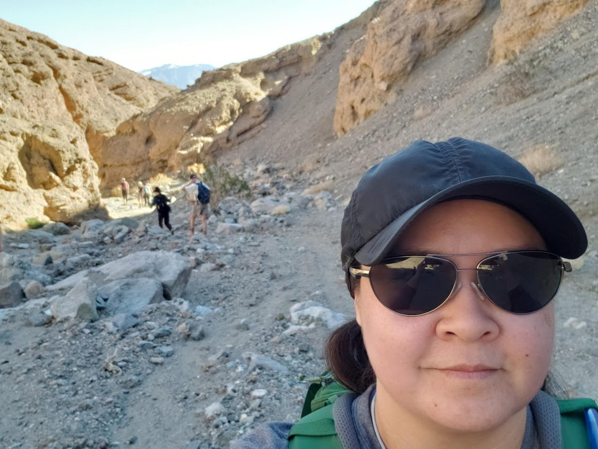 Elysia with Dr. Darrel Cowan and some other field group members in the background near Golden Canyon and Gower Gulch in Death Valley.