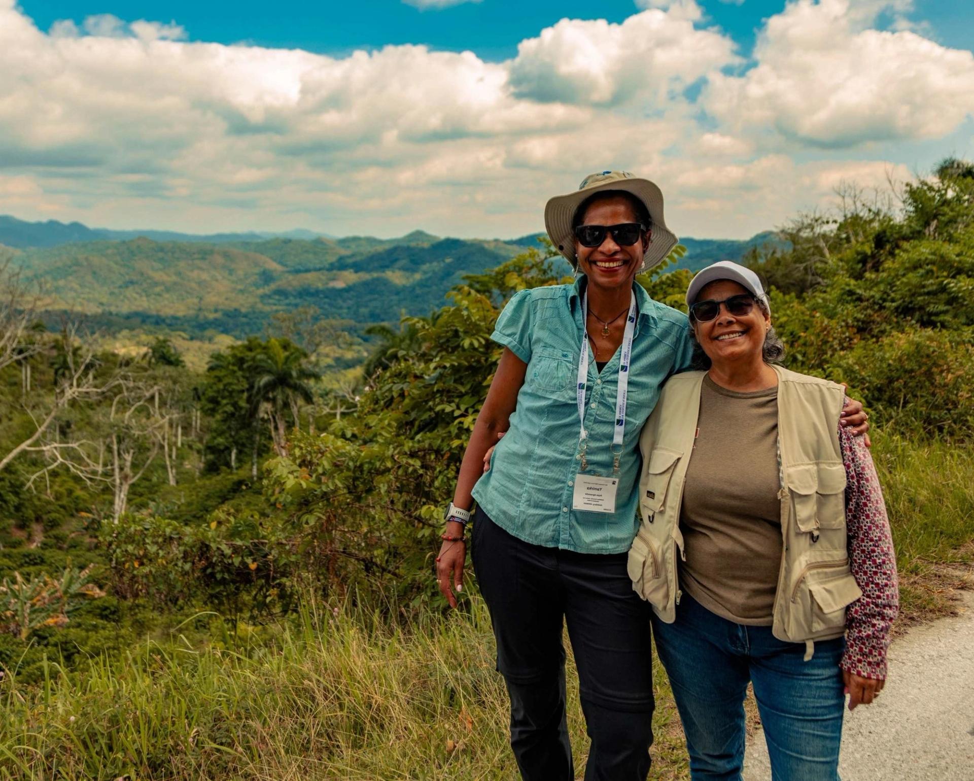 GSA geologists in front of scenic green mountains in Cuba at international field conference