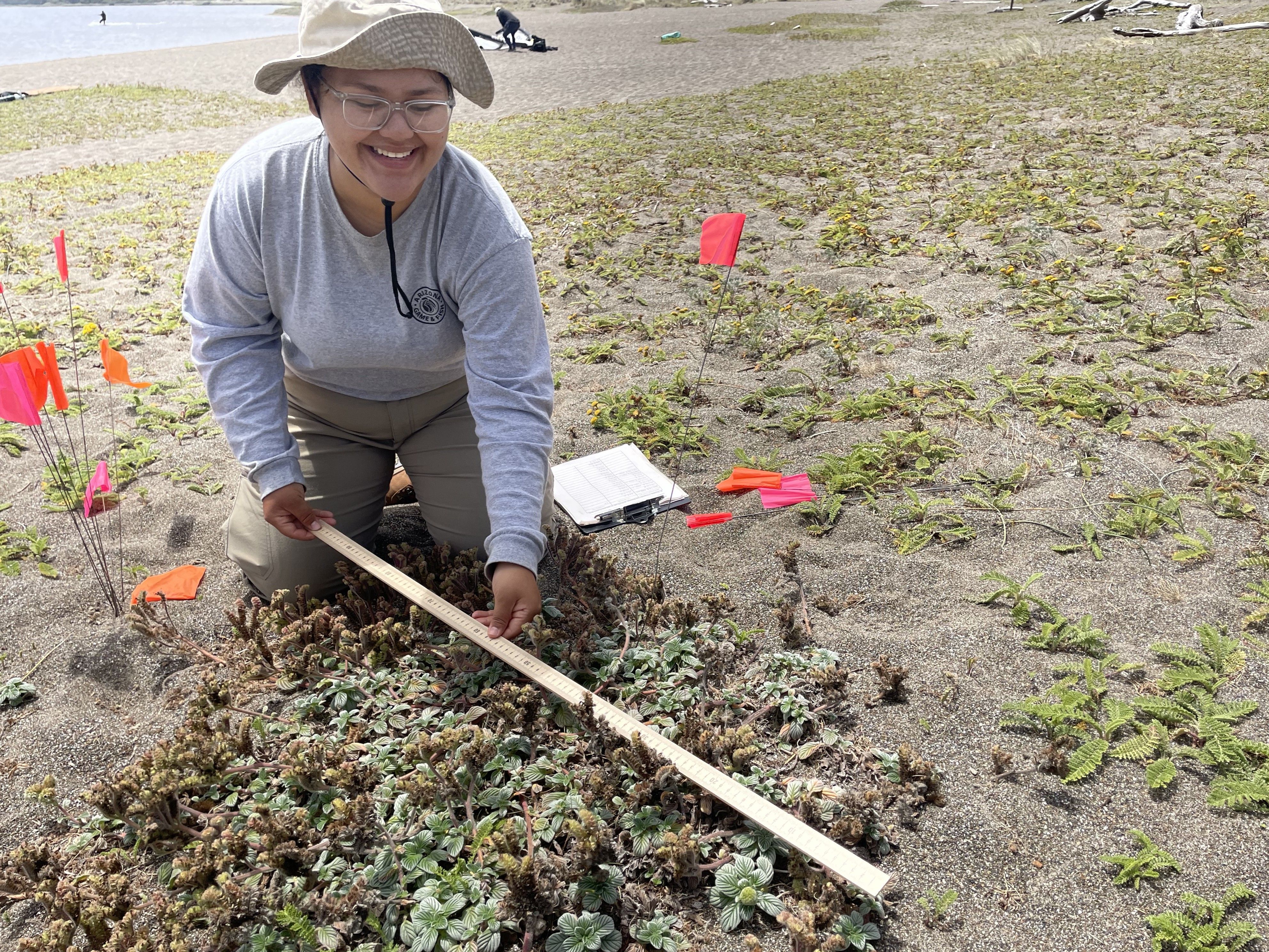 Photo of GeoCorps Participant in the field taking a measurement
