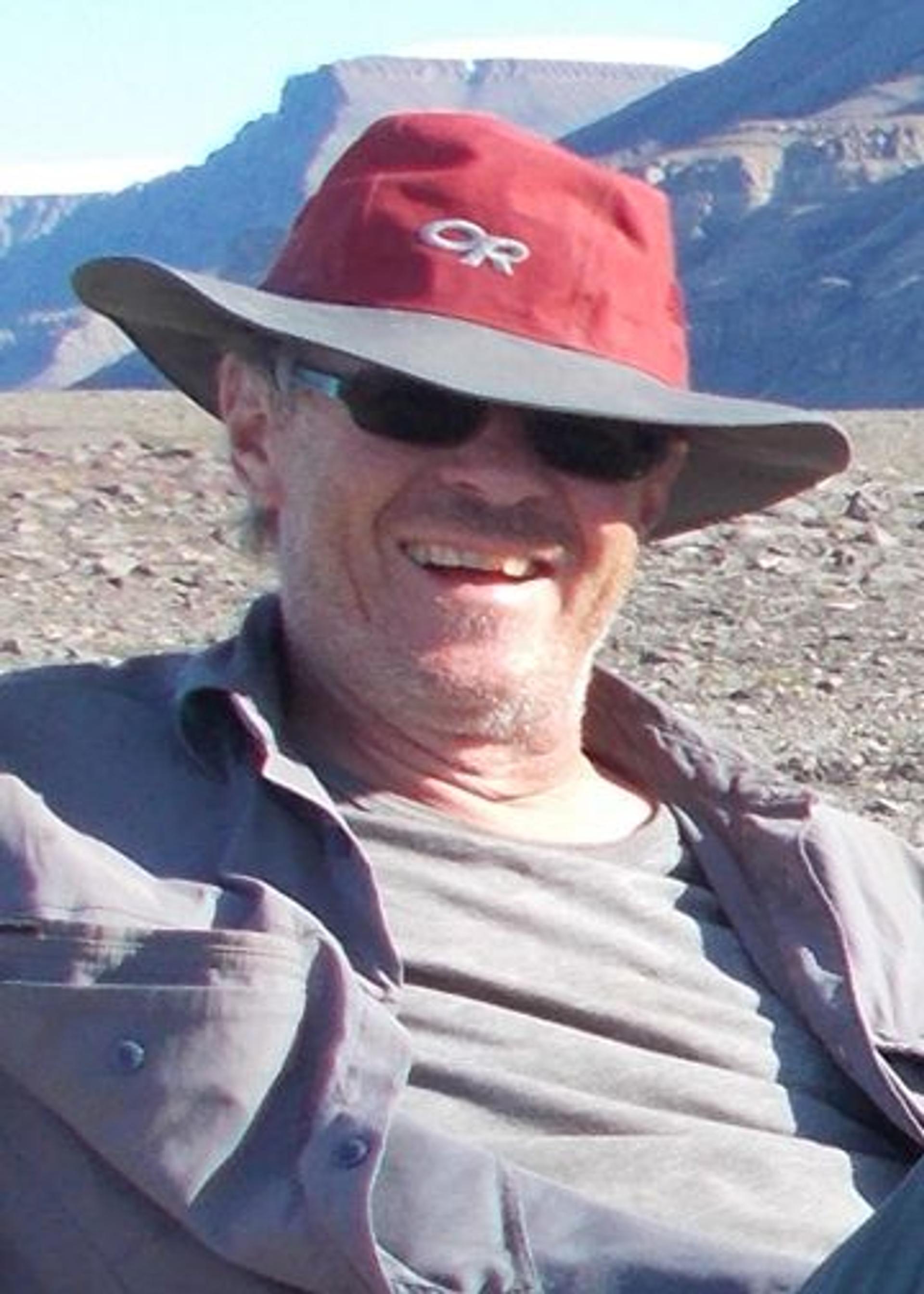 Jean H. Bédard in a red and gray hat and sunglasses.