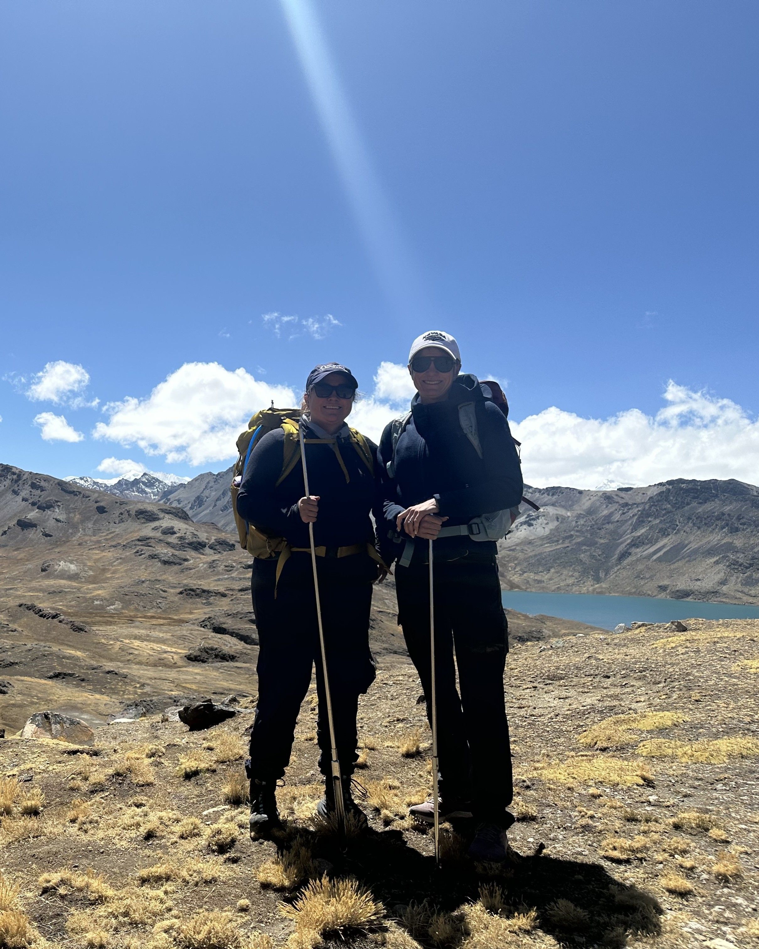 Photo of GSA Graduate Student Research Grant Recipients conducting geoscience research in the field with mountains and lake in background