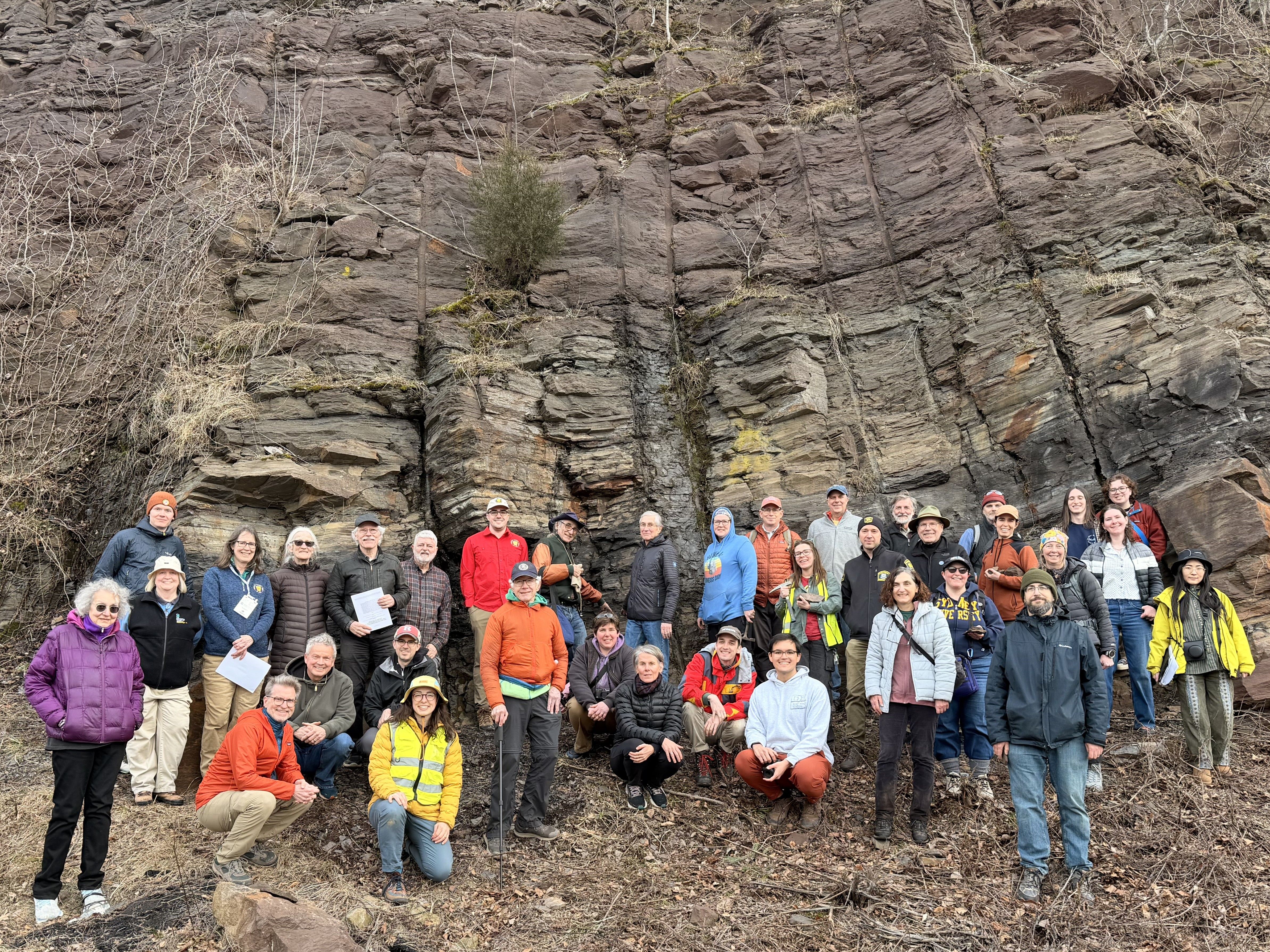 Group Photo of Field Trip attendees in front of large rock outcrop at GSA Section meeting field trip in Connecticut
