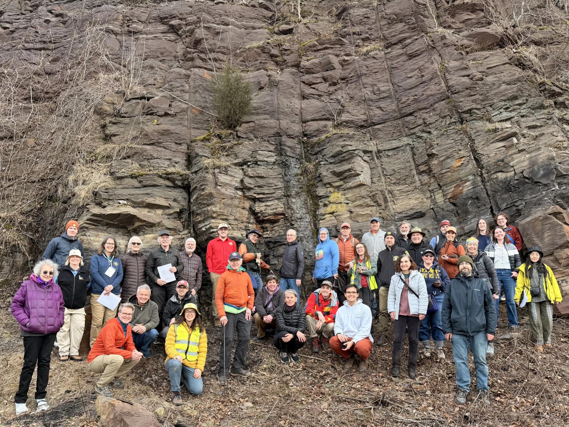 Group Photo of Field Trip attendees in front of large rock outcrop at GSA Section meeting field trip in Connecticut