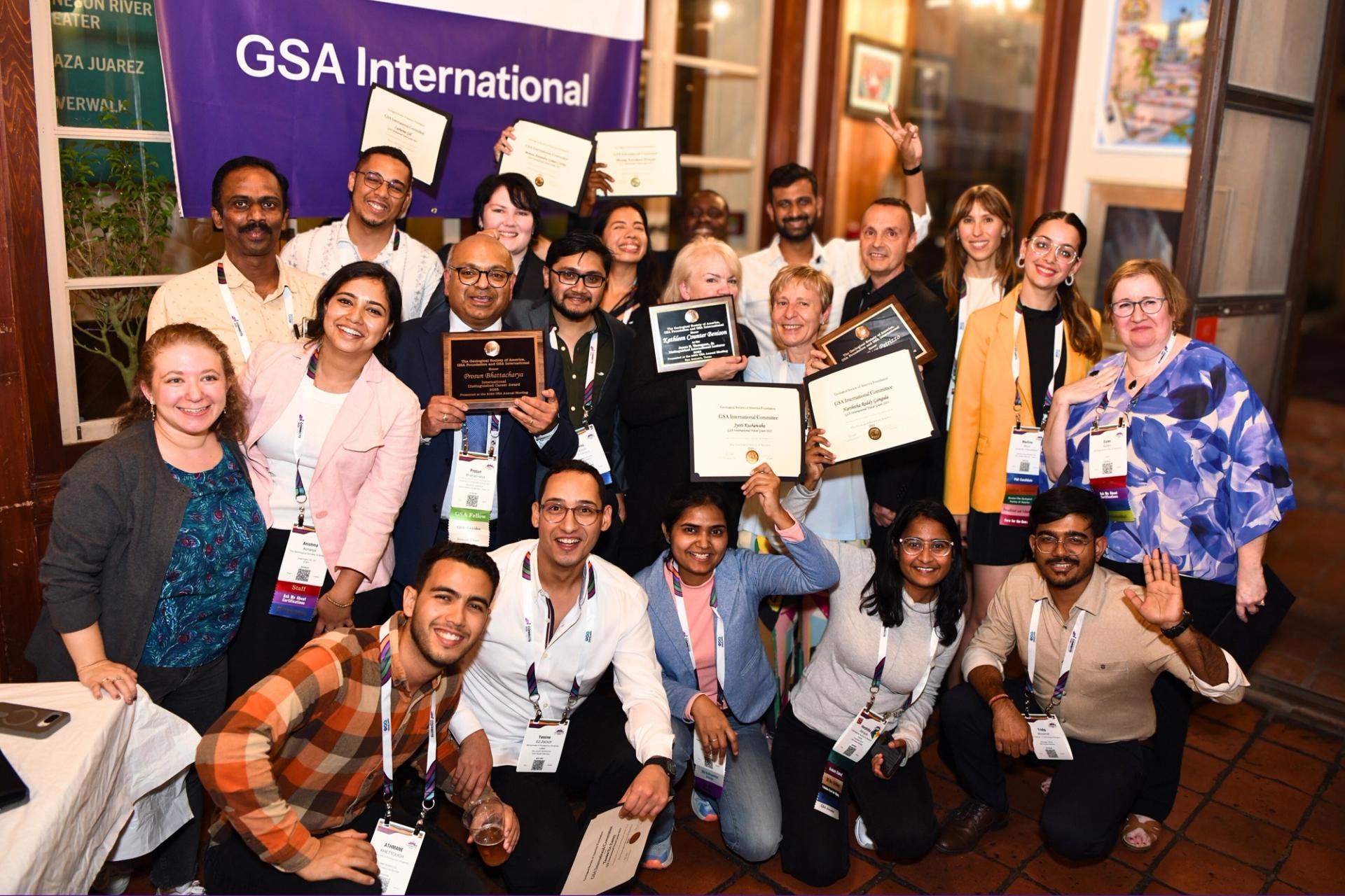 GSA Travel Grant recipients holding up award certificates at GSA International ceremony