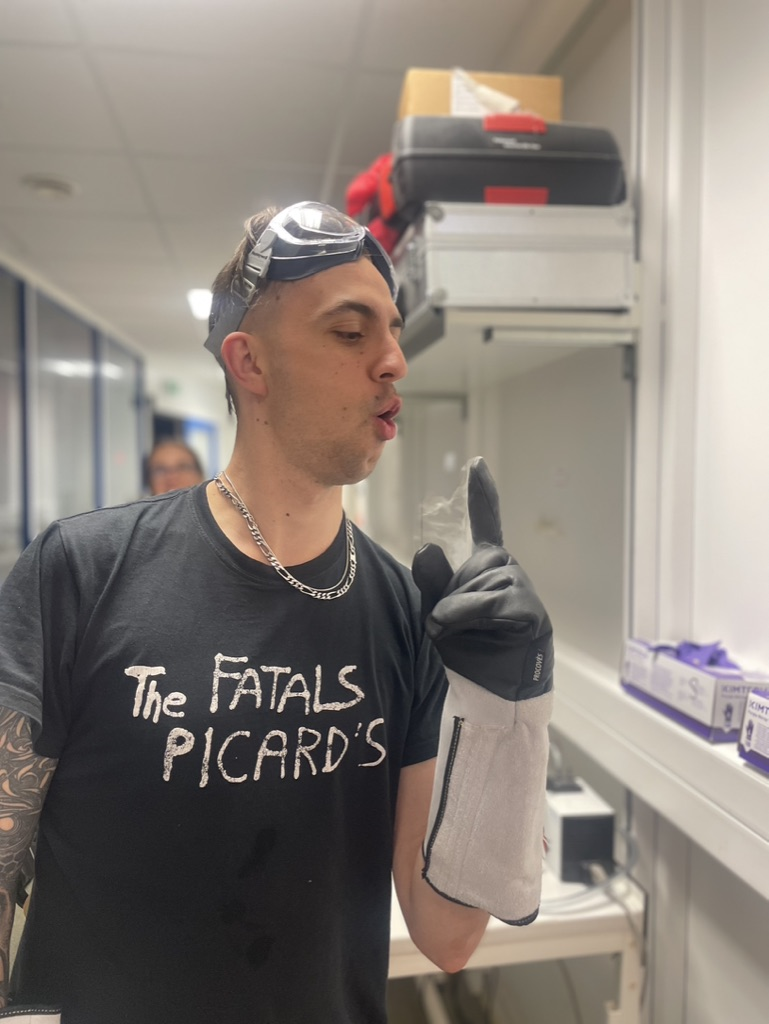 image of man wearing goggles and gloves in lab