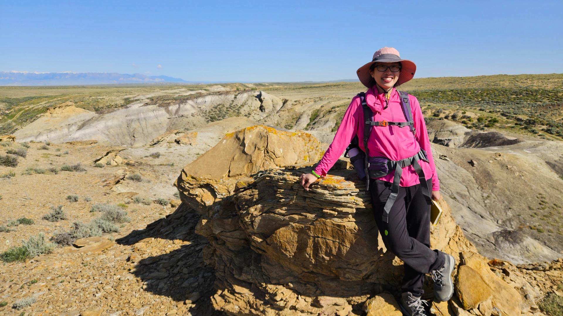 James David Lowell Field Grant Recipient at field camp leaning on rock