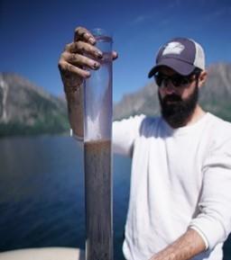 Michael McGlue holding a recently collected surface core from Jackson Lake, Grand Teton National Park (Wyoming, USA). We used this core (and others like it) to learn more about the influence of Jackson Lake dam on the lake ecosystem.