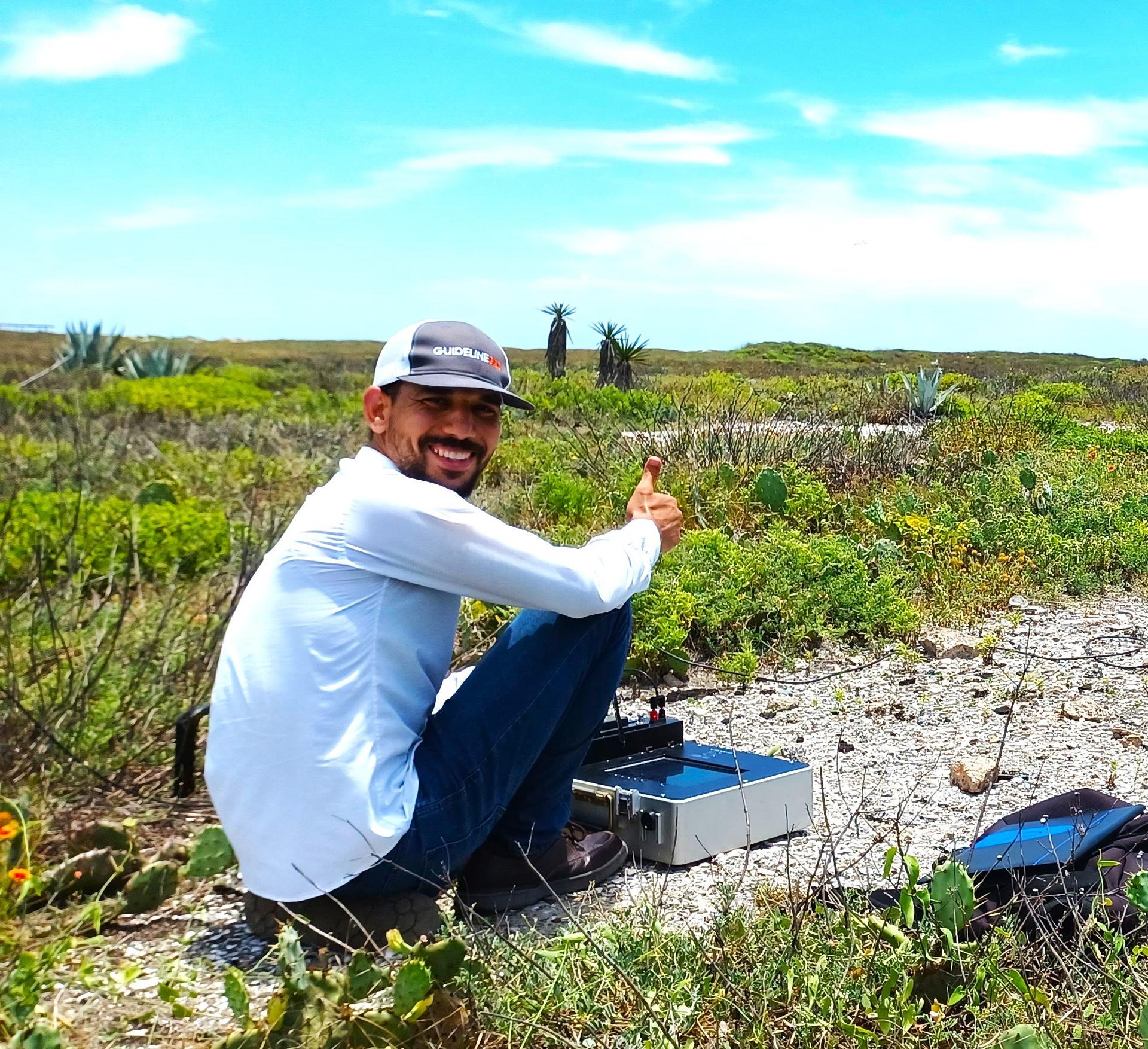 Ramadan conducting a Time-Domain Electromagnetic (TDEM) geophysical survey on Padre Island, Texas, as part of Ph.D. research — collecting subsurface data to map the island's freshwater lens and understand the delicate balance between fresh and saline groundwater that sustains this barrier island ecosystem.