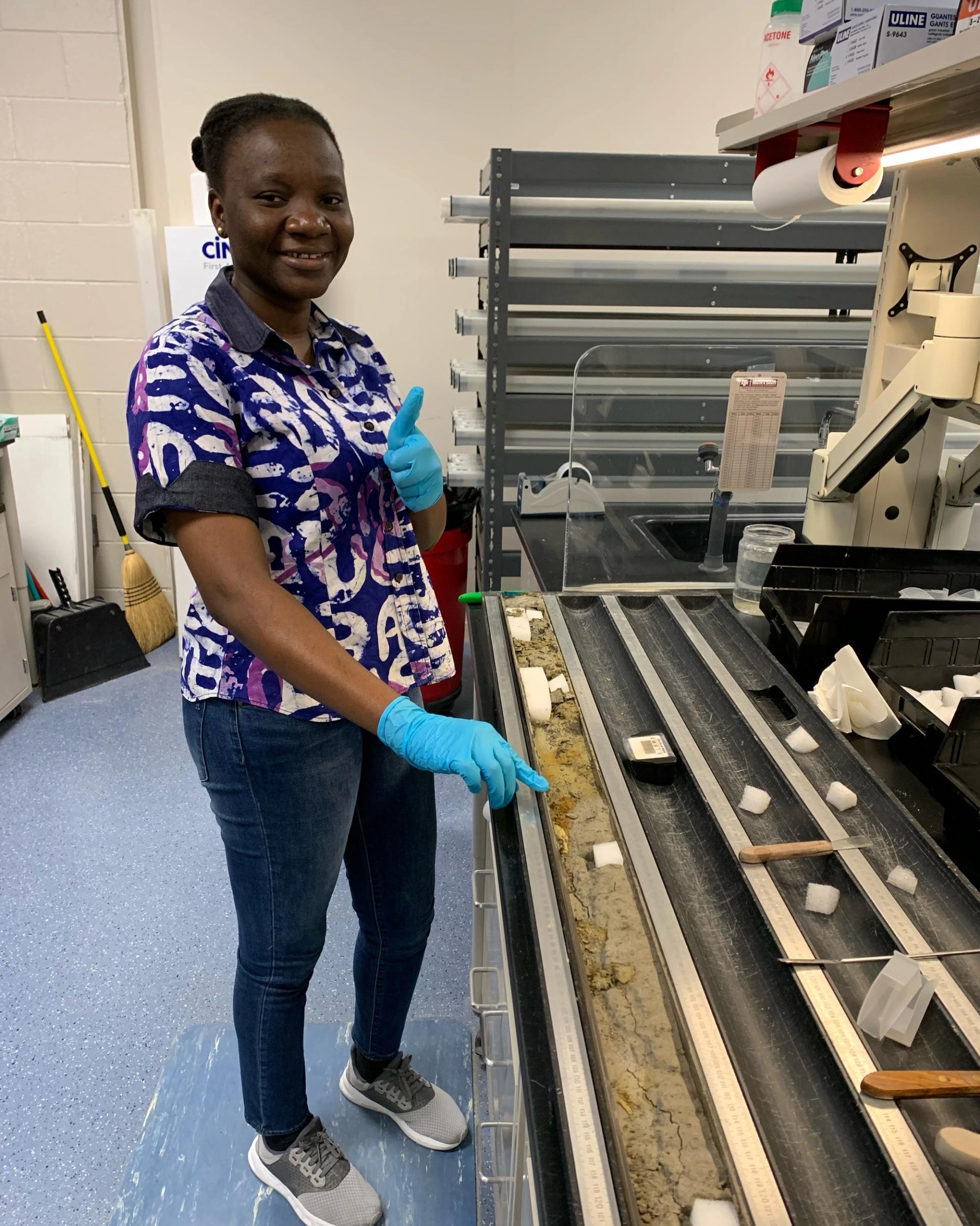 Photo of GSA Graduate Student Research Grant Recipients conducting research in the lab on rock core samples