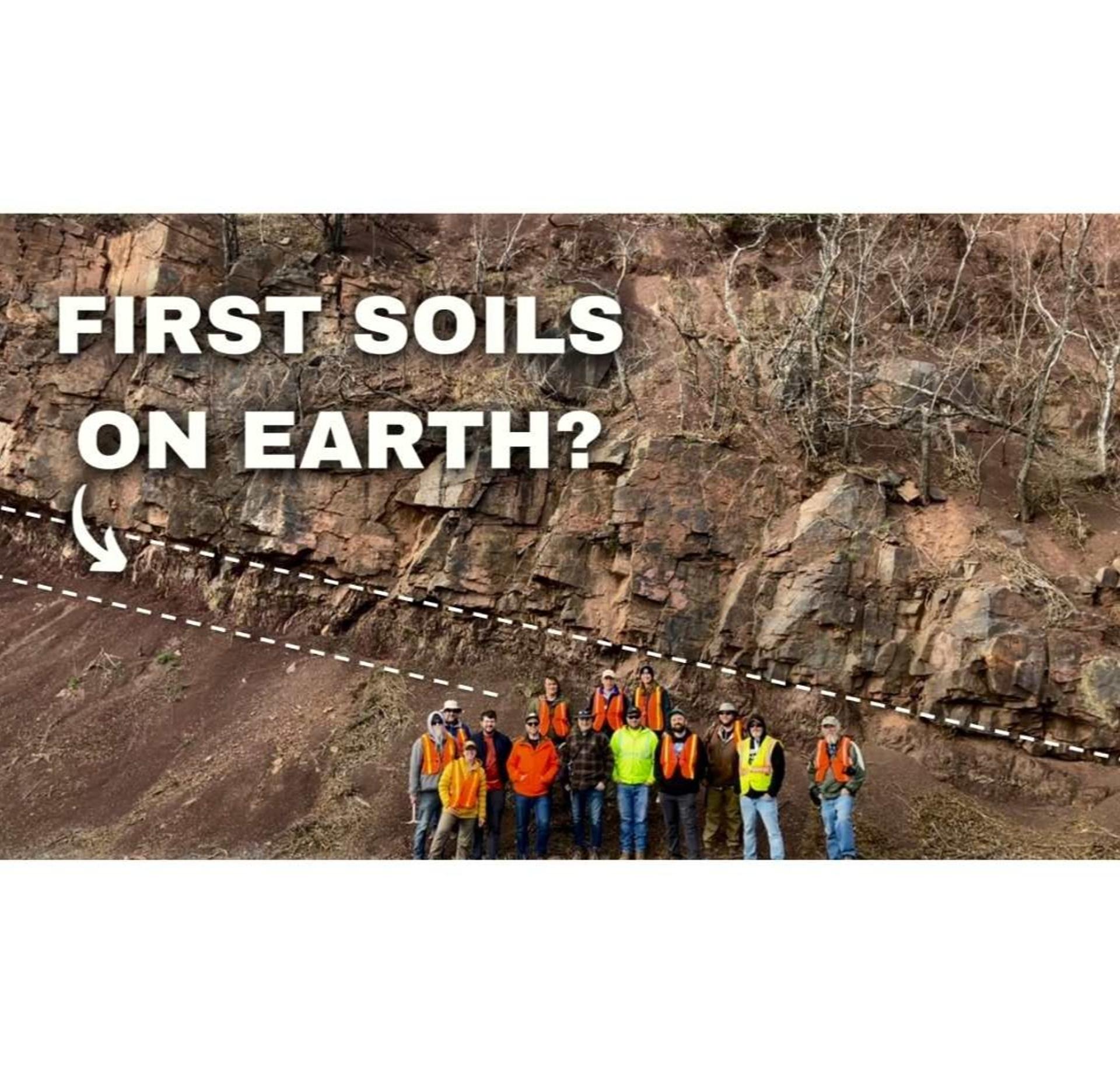 GSA Field Trip to the Devonian YouTube Thumbnail Image showing field trip participants posing in front of large outcrop of some of the oldest soils on Earth
