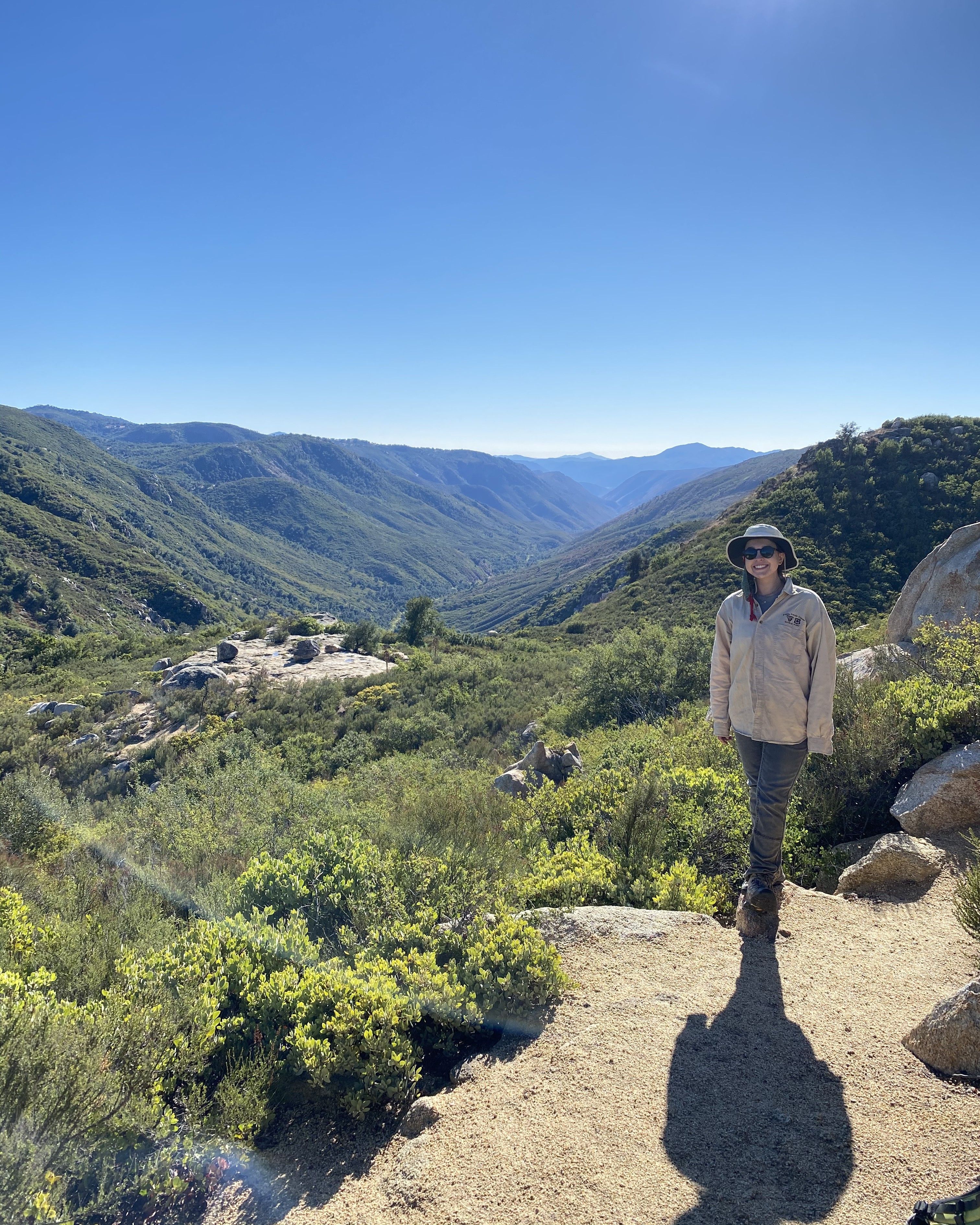 Photo of GeoCorps Participant in the field with mountains in background