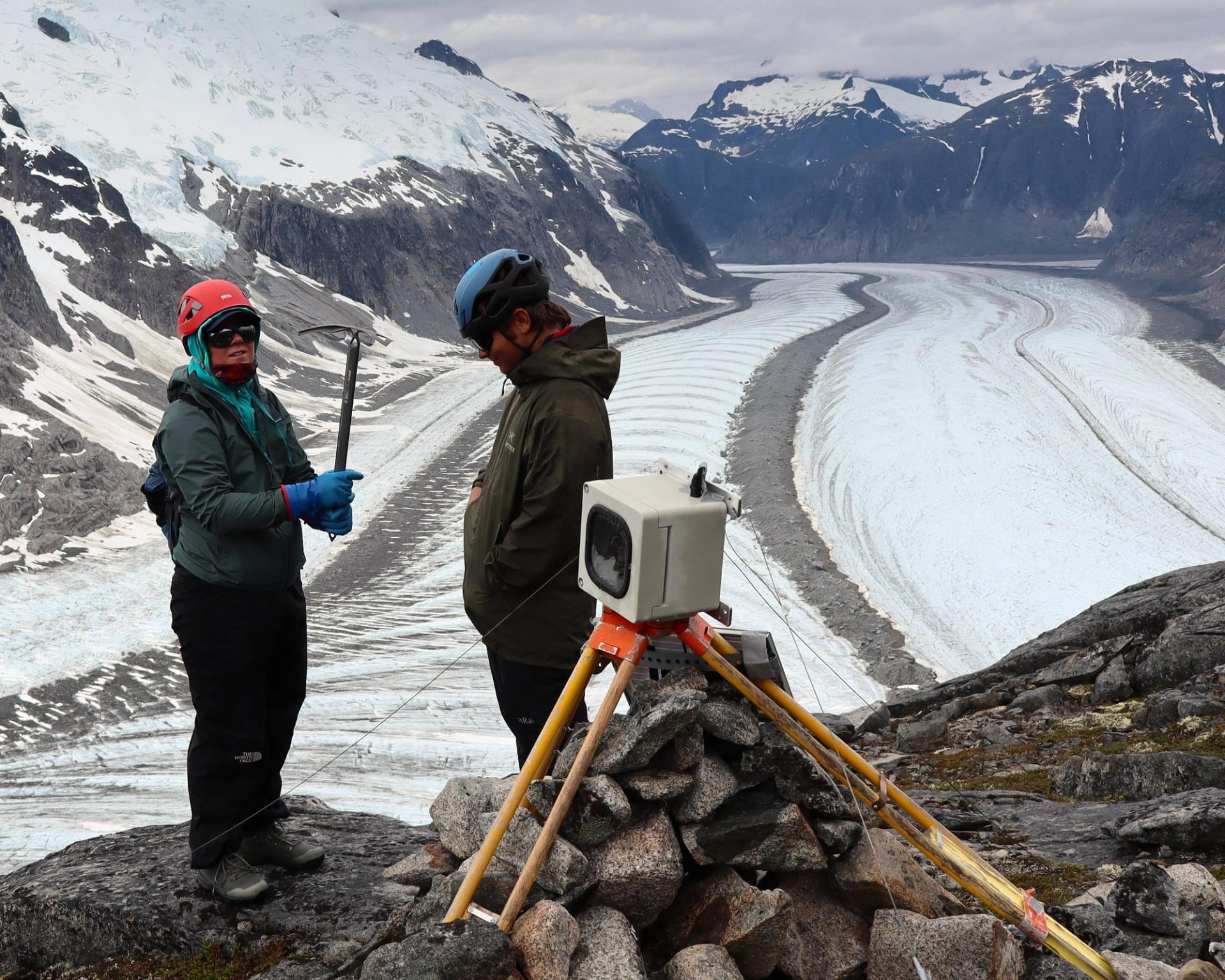 Graduate Student Research Grant Recipient working in the field with huge glacier in the background
