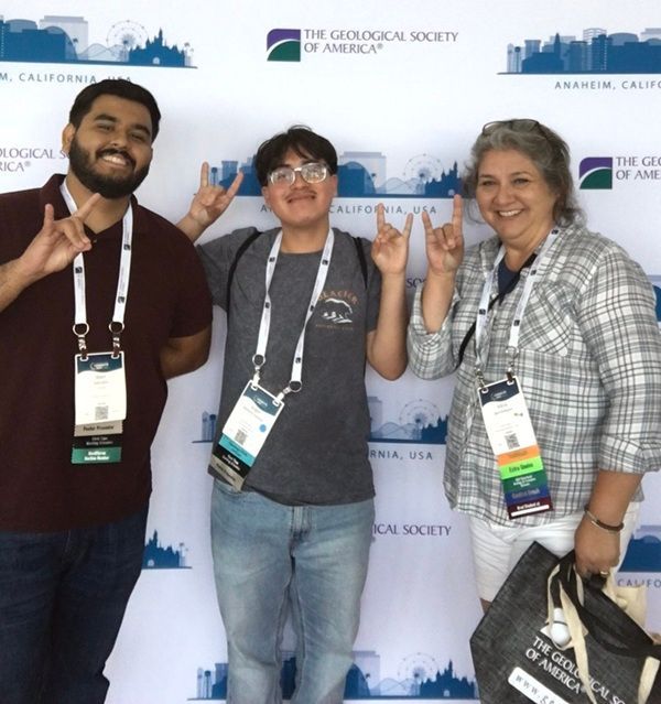 Three GSA Connects 2024 attendees pose in front of a meeting-themed photo wall.