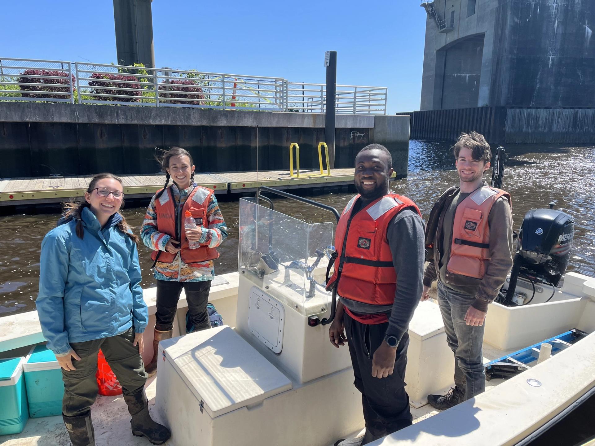 Photo of GSA Graduate Student Research Grant Recipients conducting geoscience research fieldwork by boat