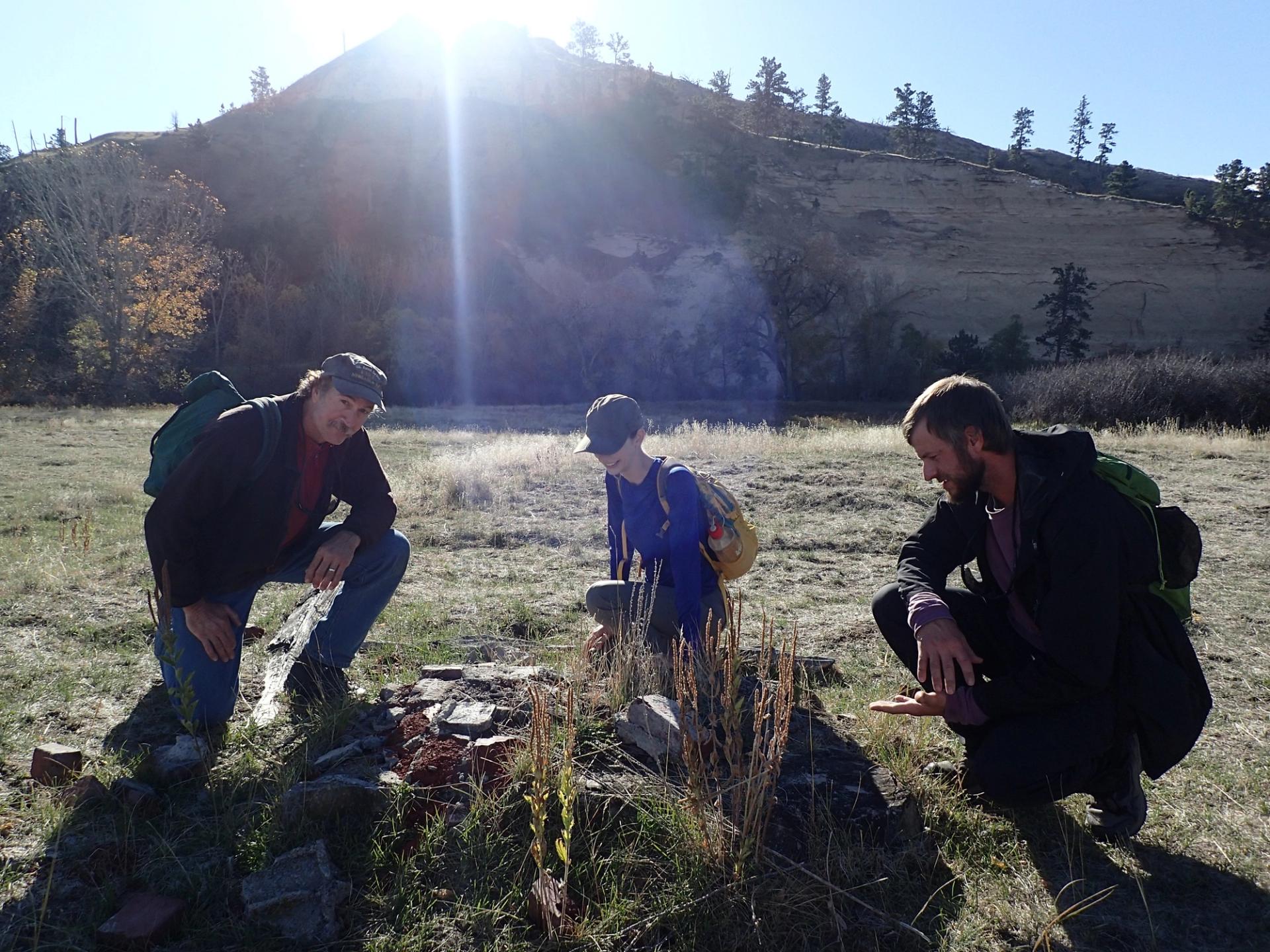 Photo of GeoCorps Participants in the field with sun setting over mountains in the background