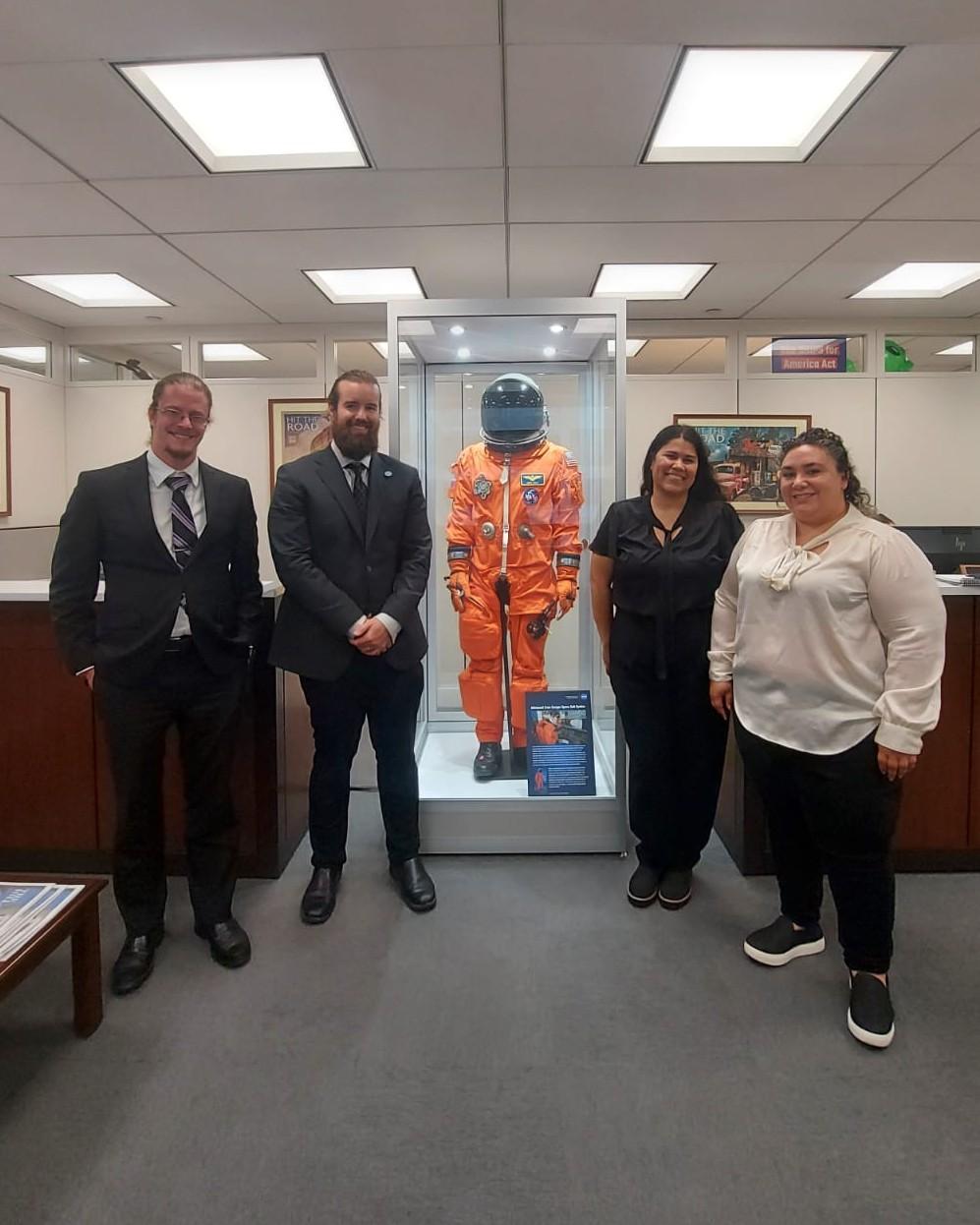 GSA geoscientists posing next to a space suit at Senator Kelly Meeting on Congressional Visits Day