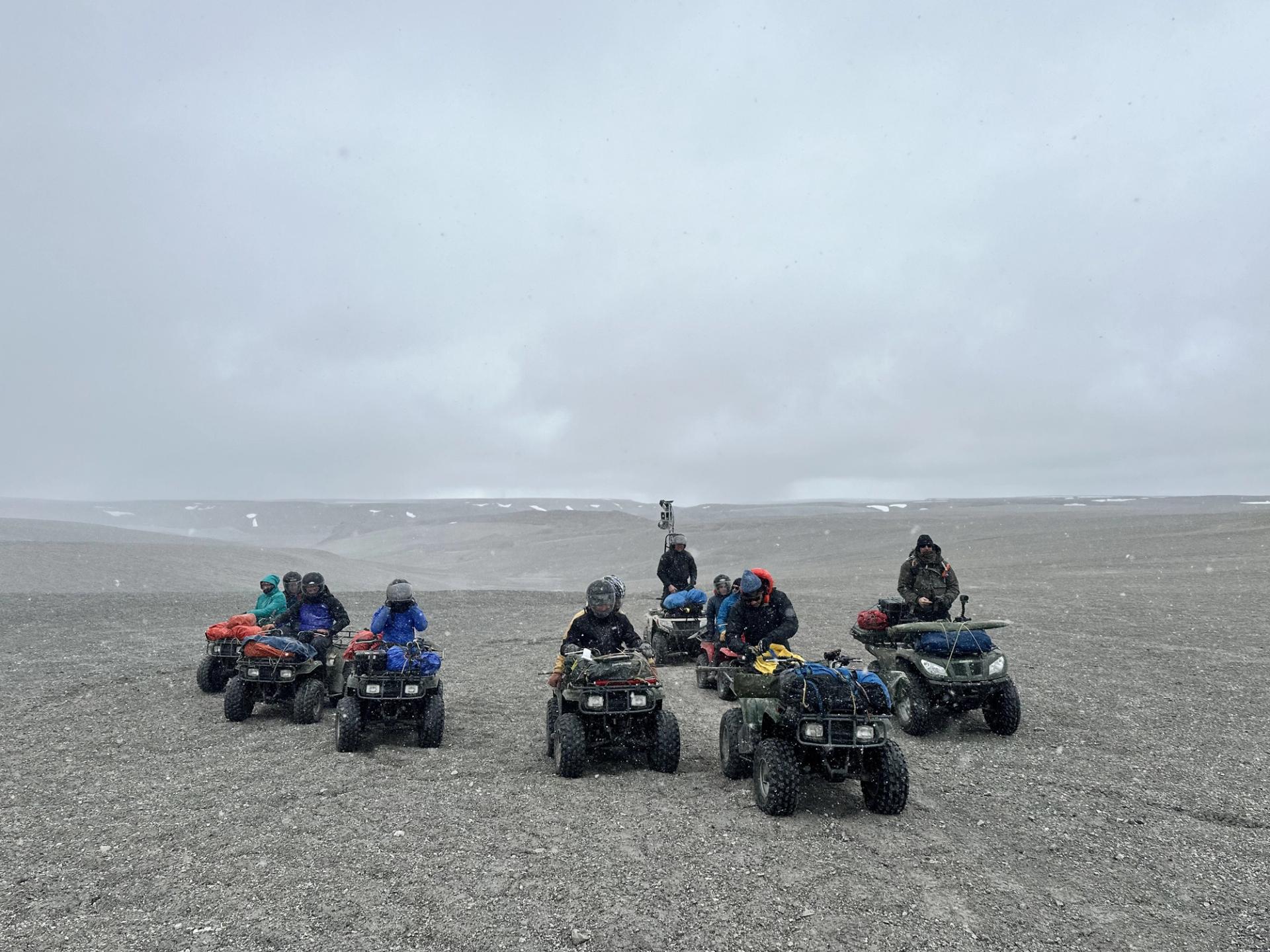 Photo of GSA Graduate Student Research Grant Recipients conducting geoscience research fieldwork in 4-wheelers across barren landscape