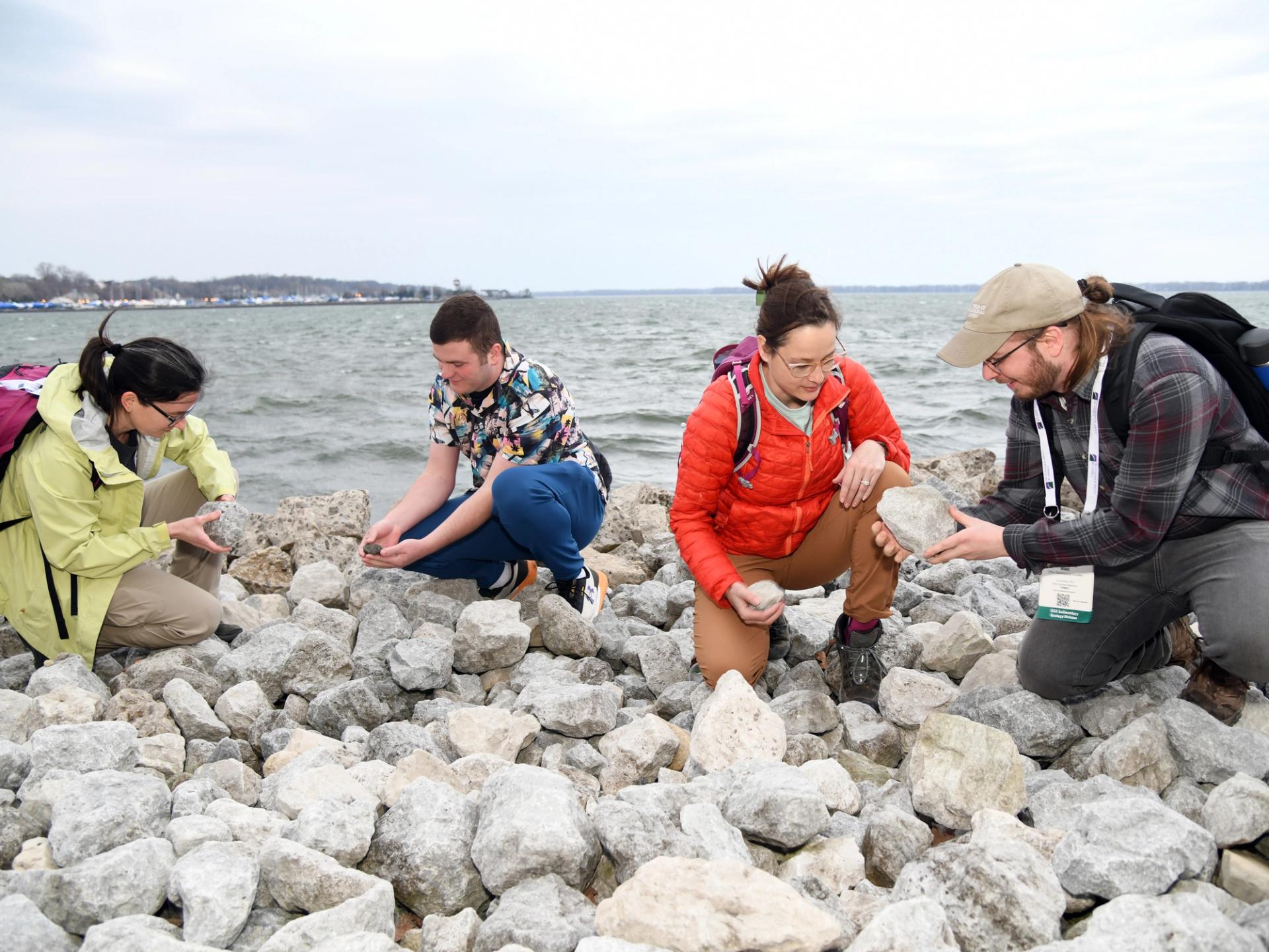 Photo of GSA meeting attendees examining rocks along coastline