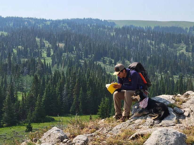 Photo of GSA Graduate Student Research Grant Recipients conducting fieldwork with dog