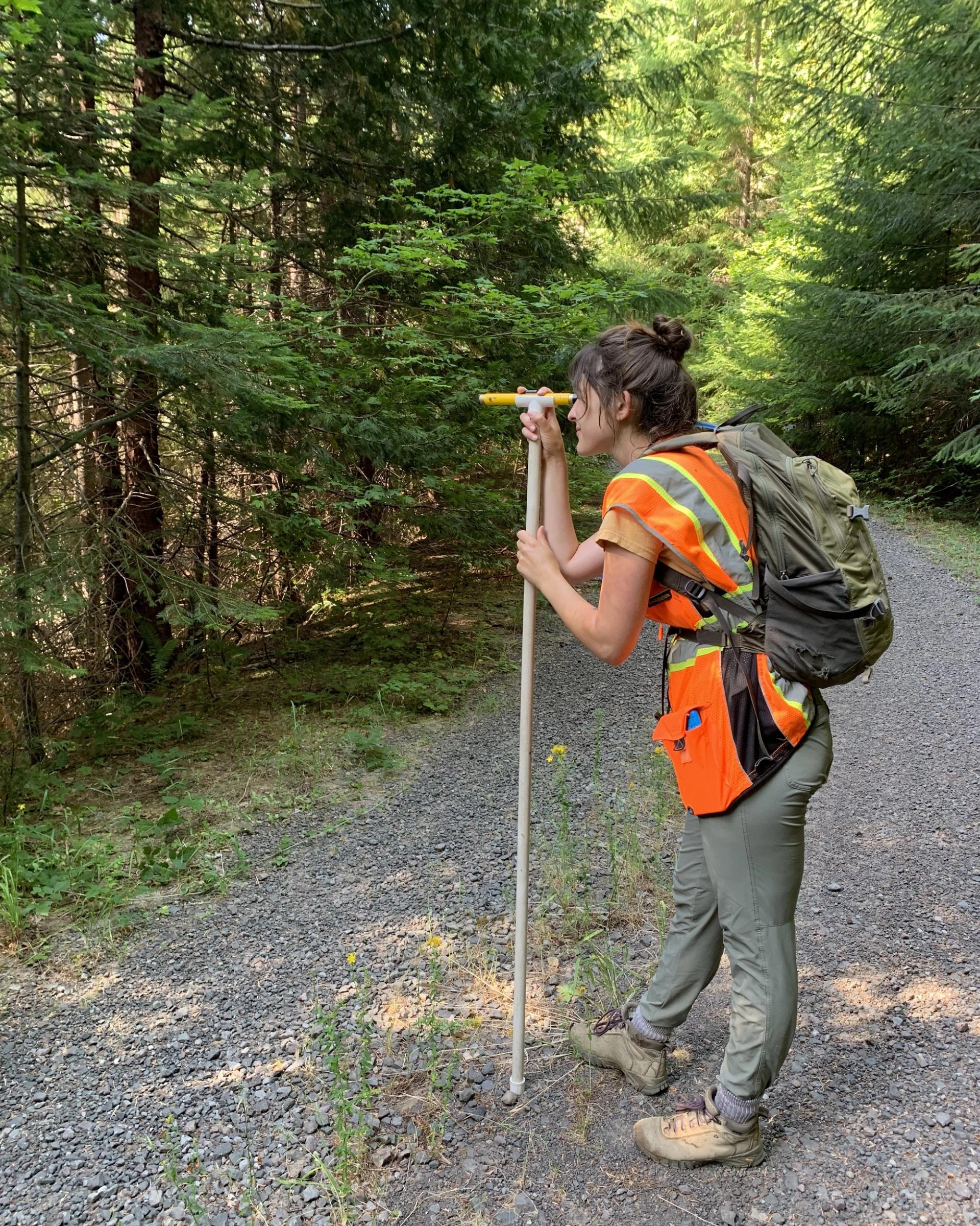 Photo of GeoCorps Participant taking measurement in the field