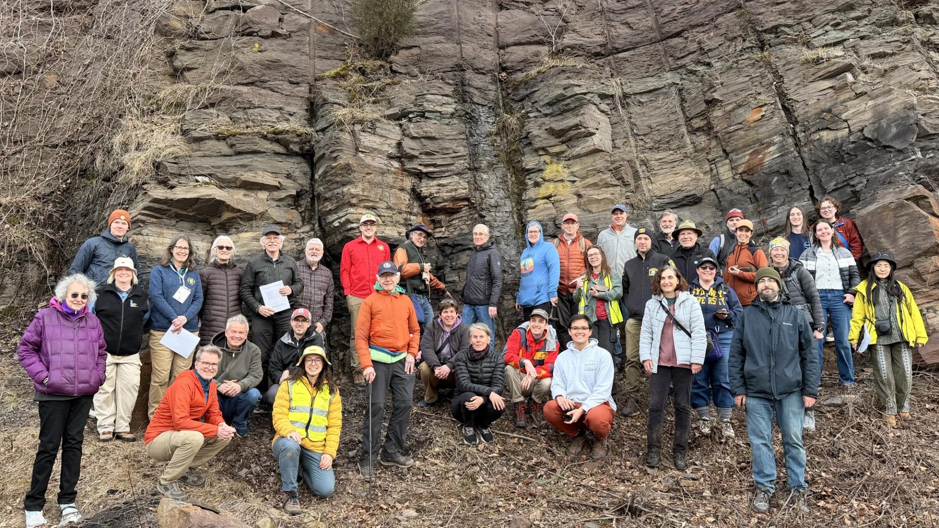 Northeastern GSA Field Trip group photo in front of large rock outcrop