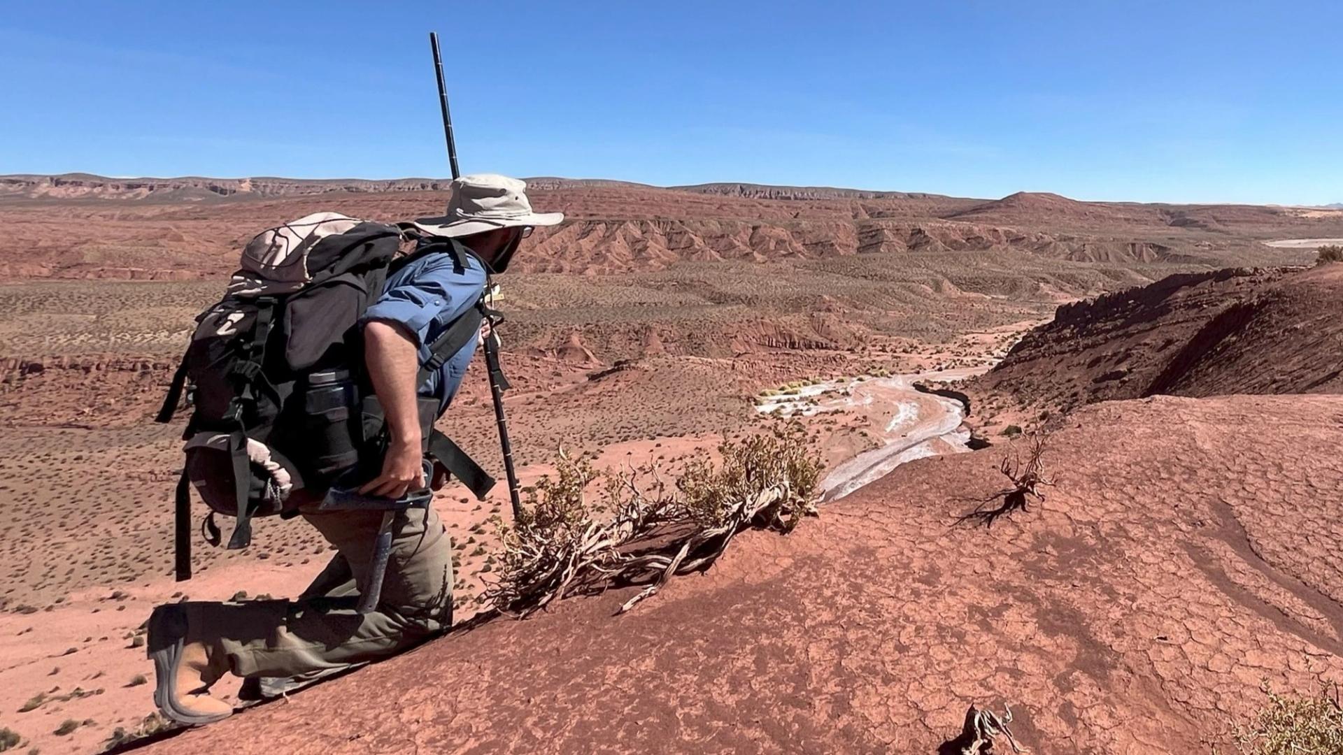 Graduate Student Research Grant Recipient conducting fieldwork in red desert with Jacob staff