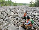 Researchers in a boulder field