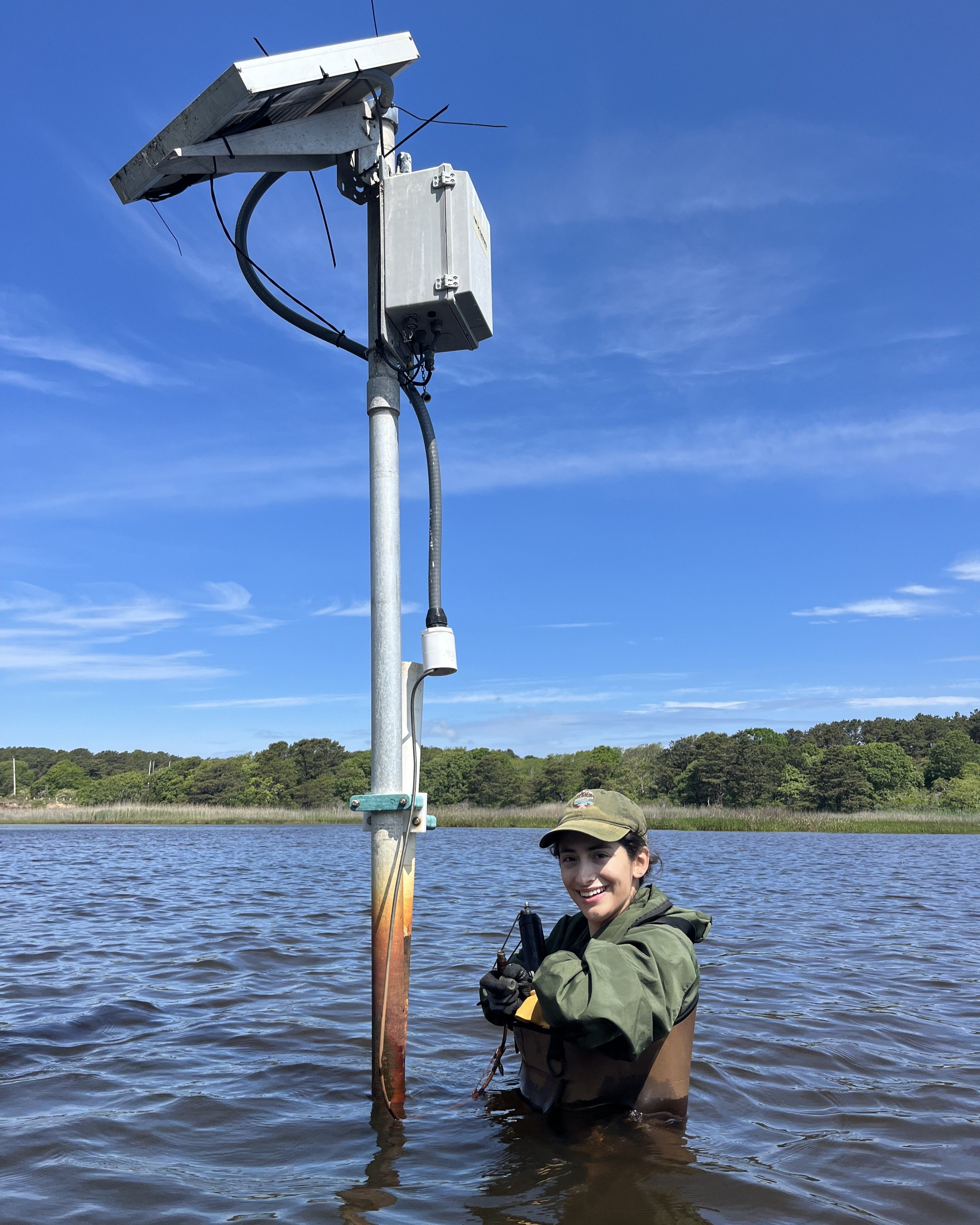 Photo of Scientists in the Parks Participant conducting fieldwork waist deep in a lake taking measurements