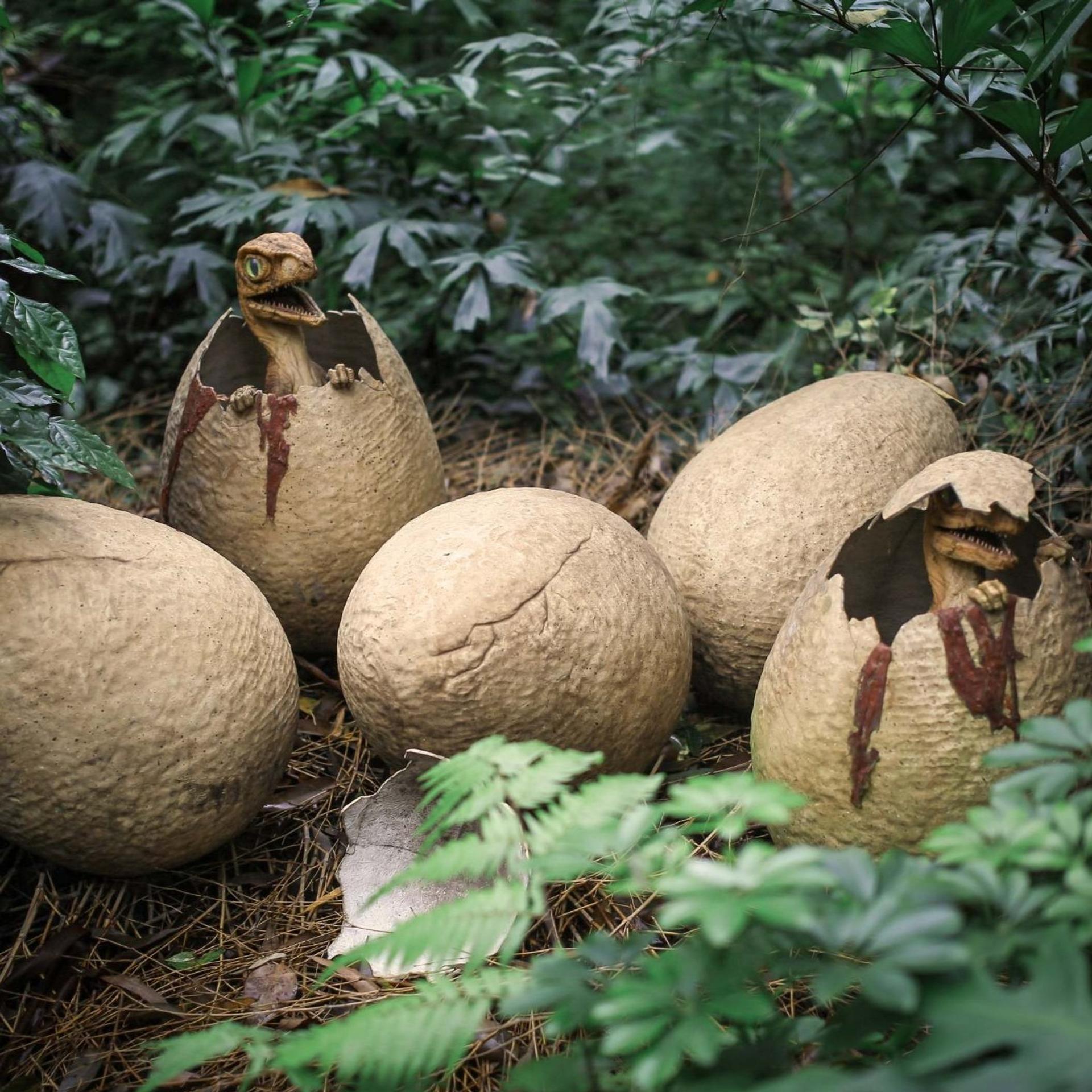 Ancient dinosaurs hatching from eggs