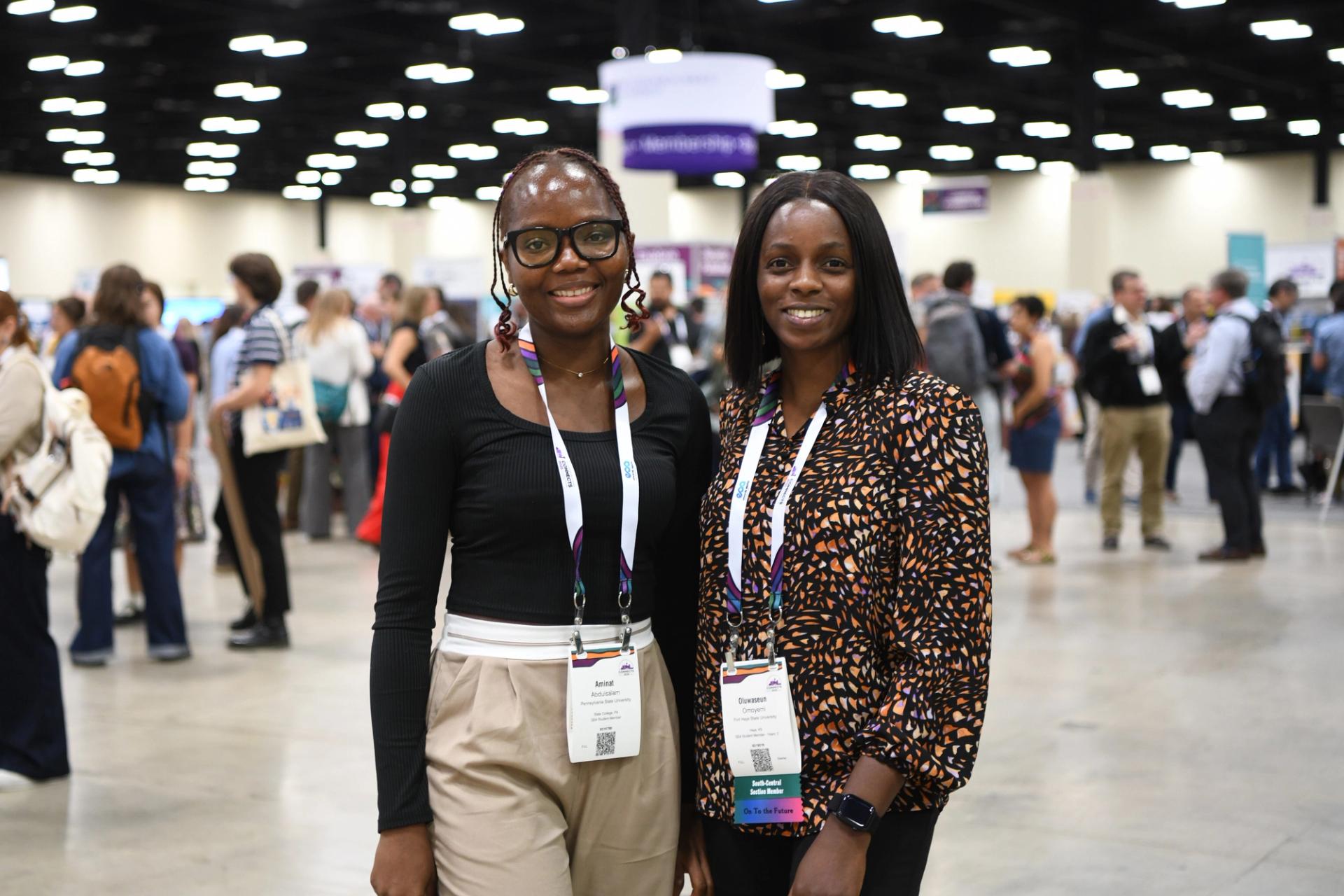 GSA Connects Meeting Attendees posing in front of crowded exhibit hall