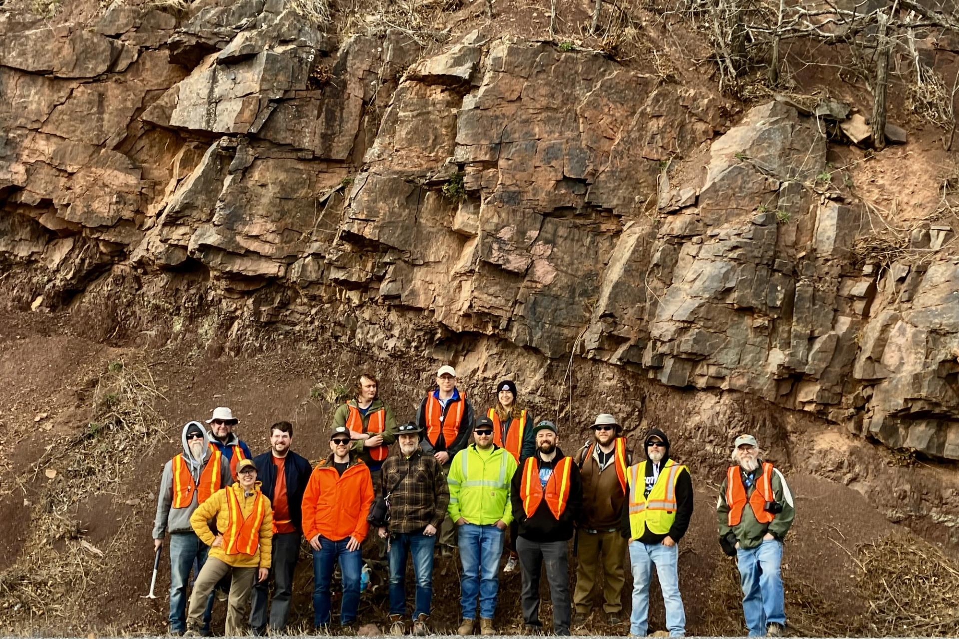 GSA-Southeastern Section Meeting Field Trip participants posing for group photo in front of large rock outcrop in West Virginia