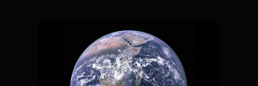 View of Earth from space showing Africa and Europe, with swirling clouds and blue oceans, set against the black backdrop of the cosmos.