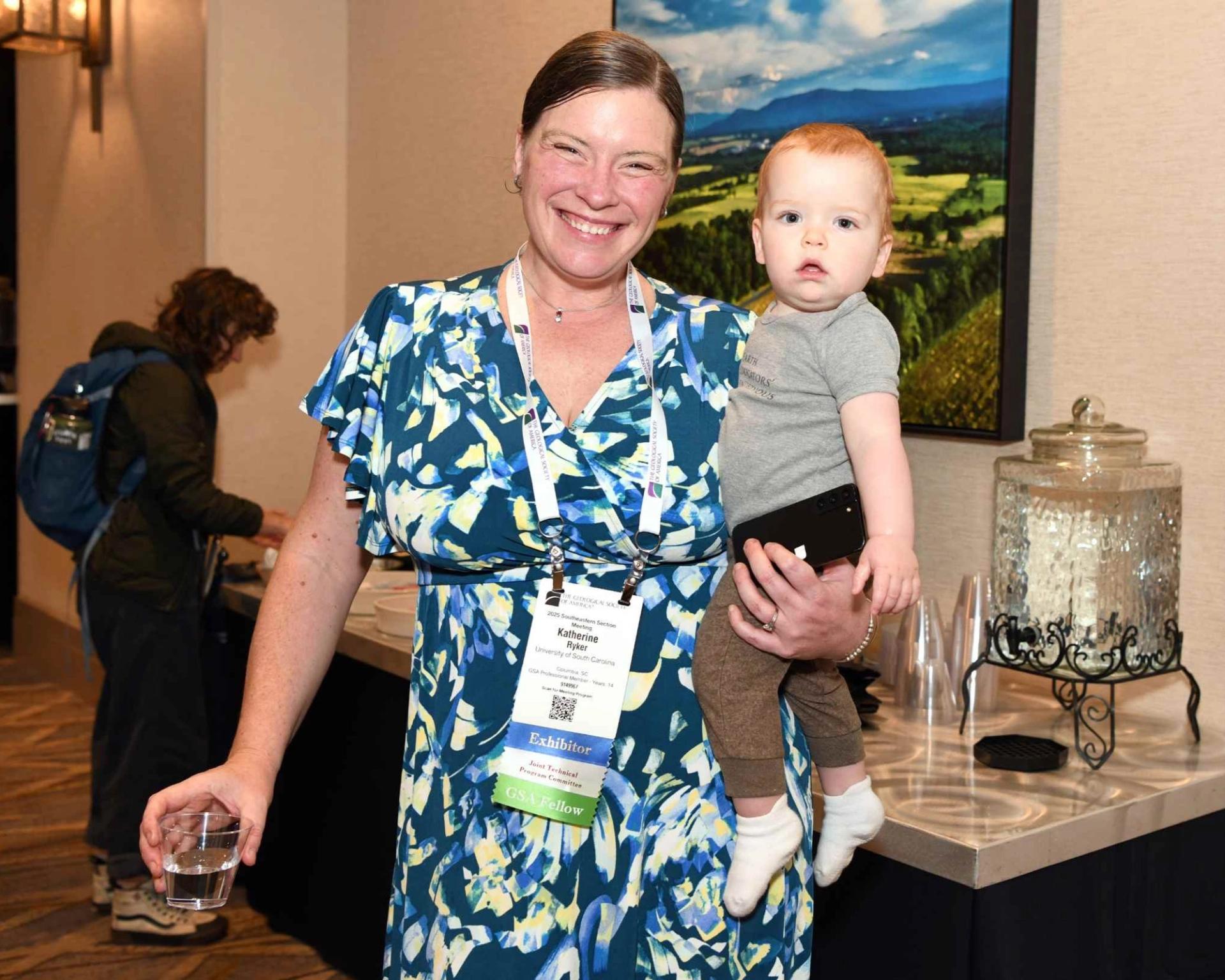 GSA Section Meeting attendee holding baby inside Convention Center