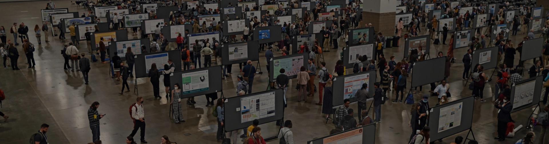 Darkened image of crowded poster hall from above at GSA Connects 2022 in Denver