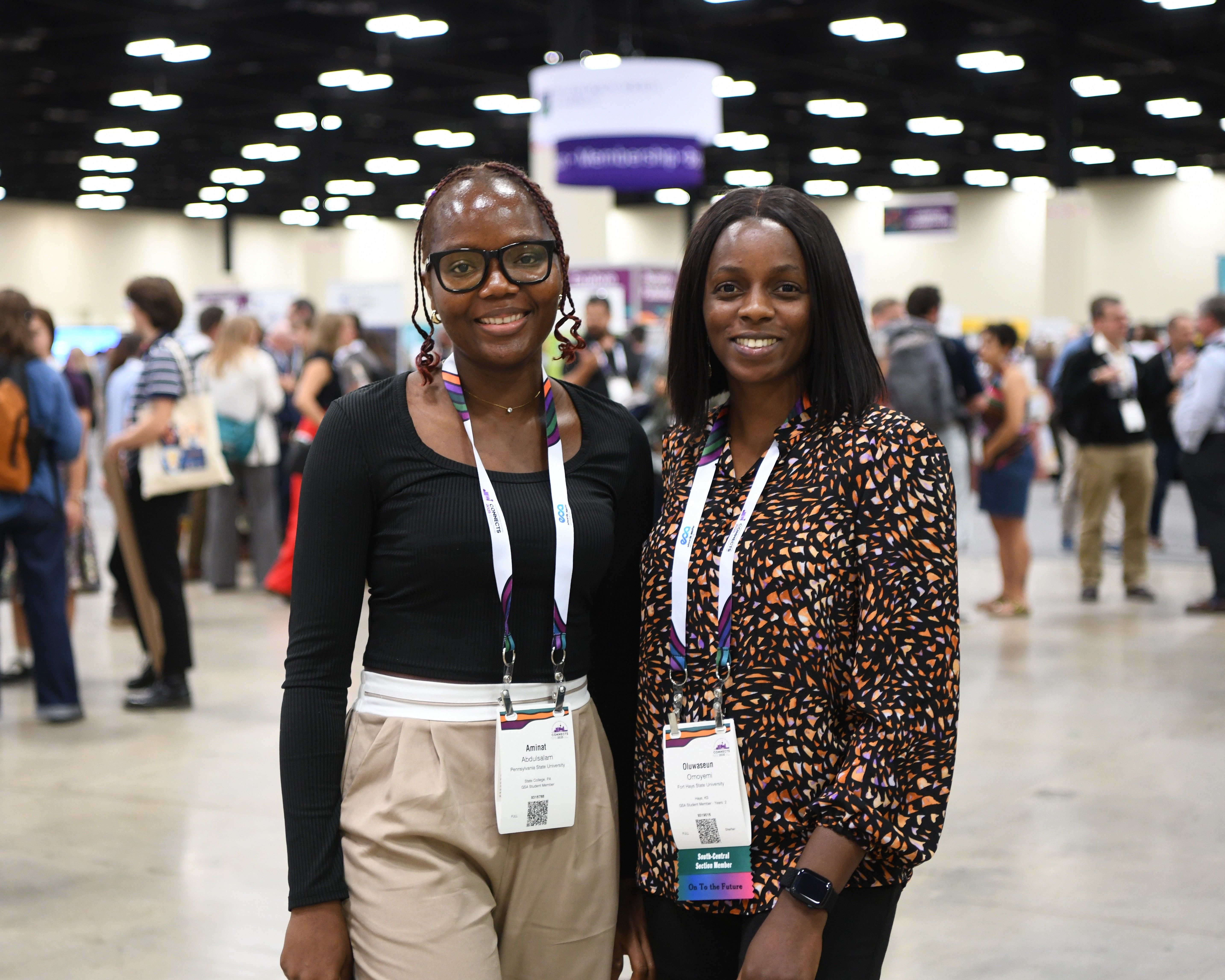 Meeting attendees posing for photo together in front of busy exhibit hall at GSA Connects meeting