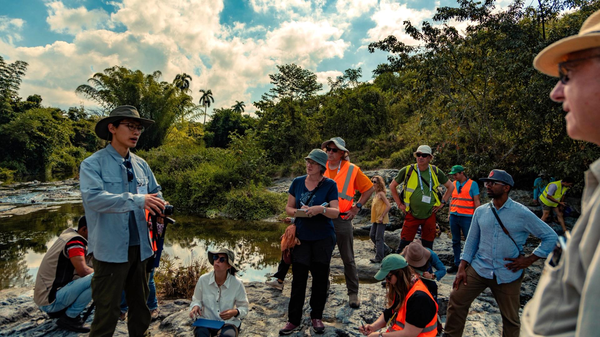 GSA field trip participants in Cuba engaging in conversation about the local geology while in the field