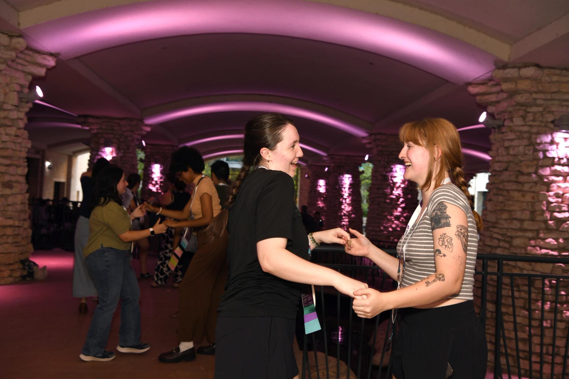 Two GSA Connects 2025 attendees learn how to salsa at the Icebreaker Reception in San Antonio, TX.