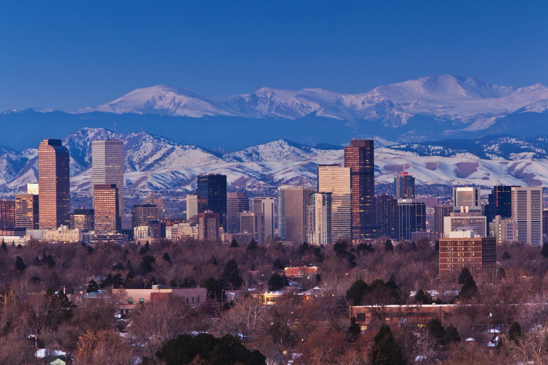 Landscape view of downtown Denver, Colorado, USA with the mountains in the background with snow caps