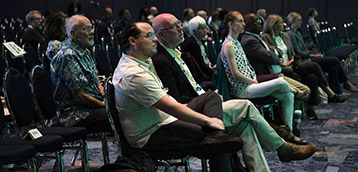 Conference attendees listen intently to a talk.