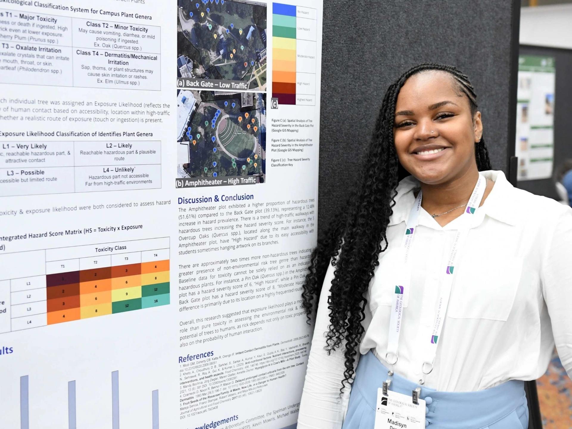 Presenter smiling next to poster at GSA meeting