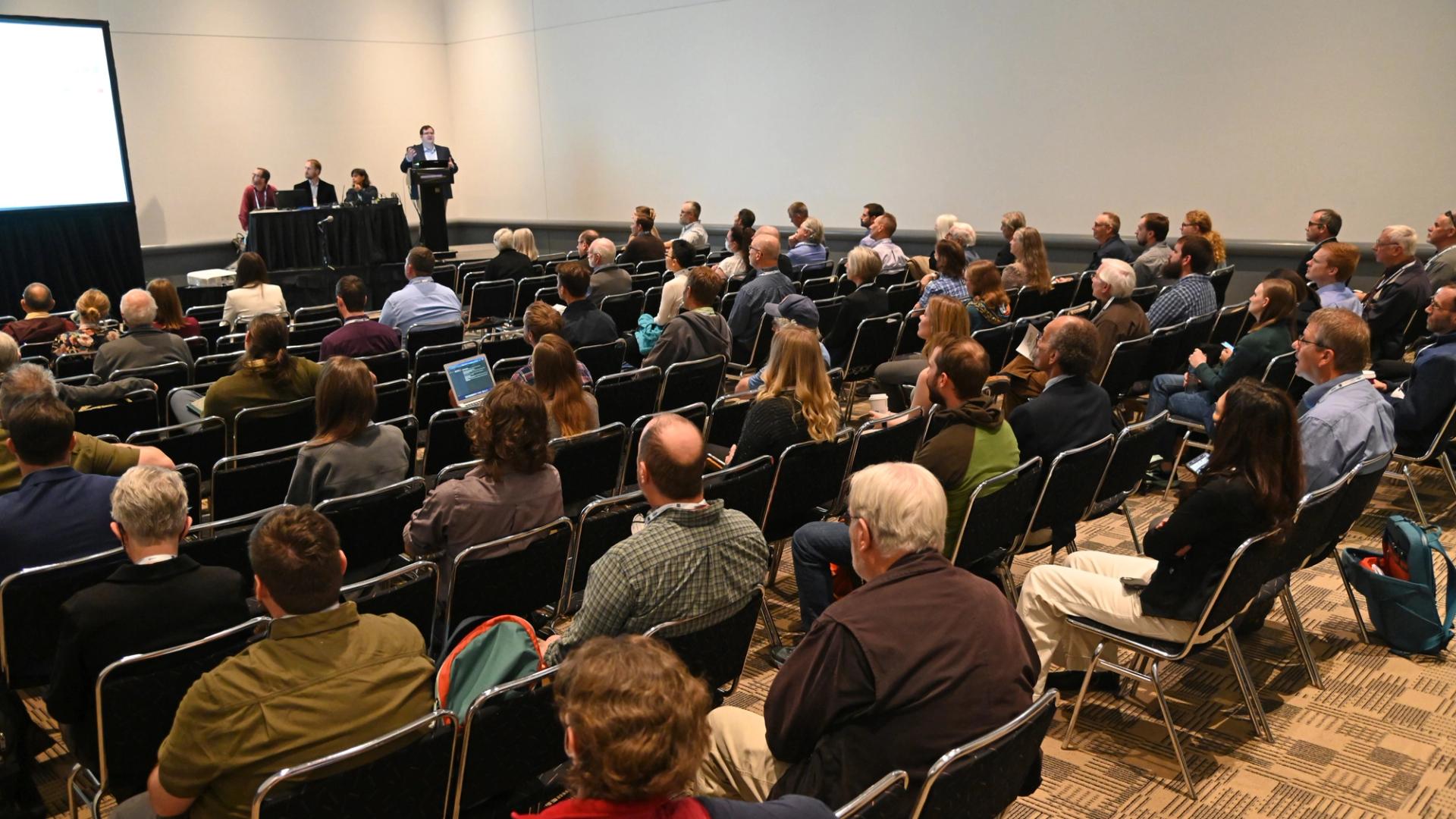 Oral presenter speaking in front of large crowd at GSA meeting