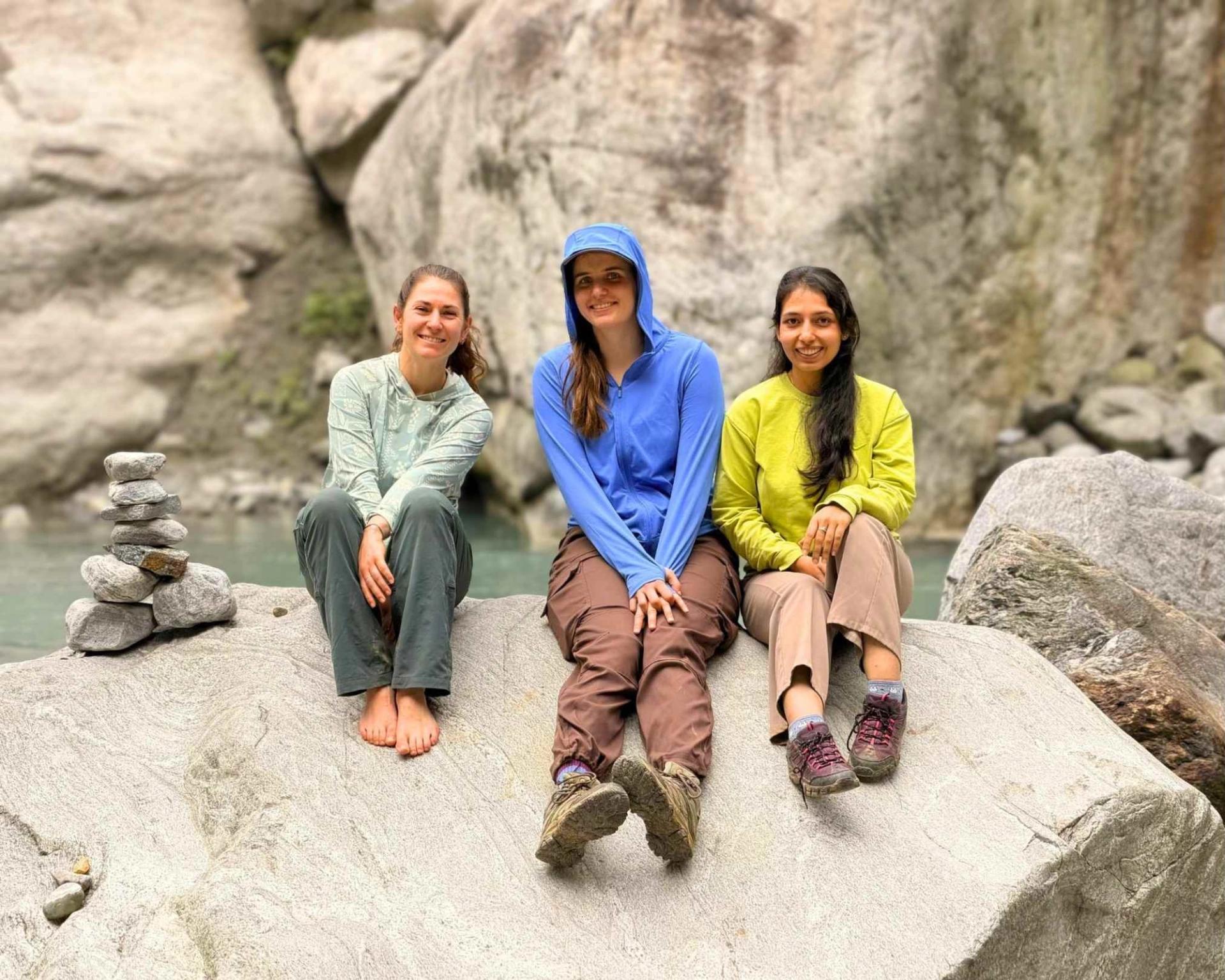 Three young geologists sitting on rock at Nepal Penrose Field Trip