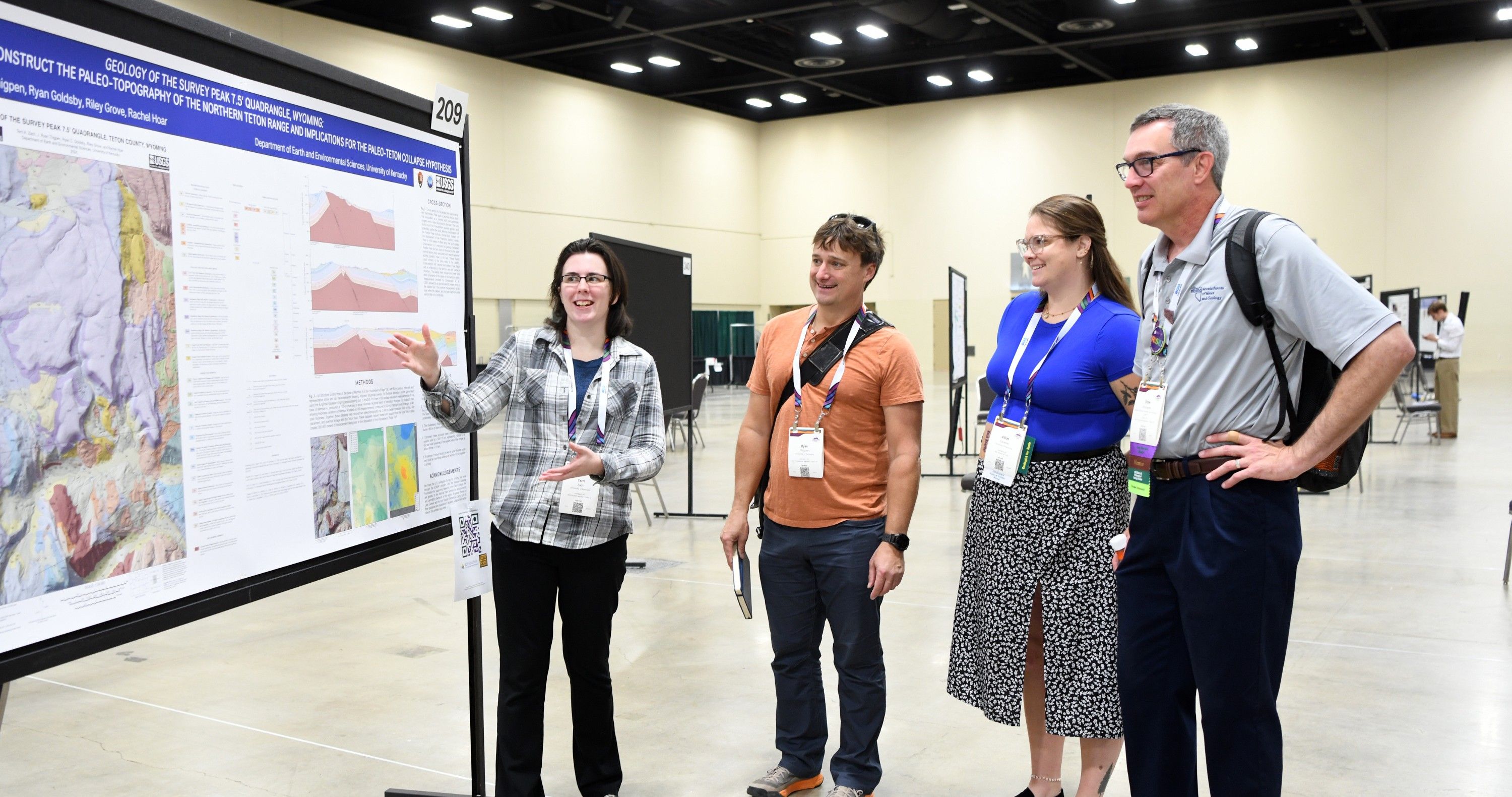 Connects 2025 attendee presenting their poster to other attendees.