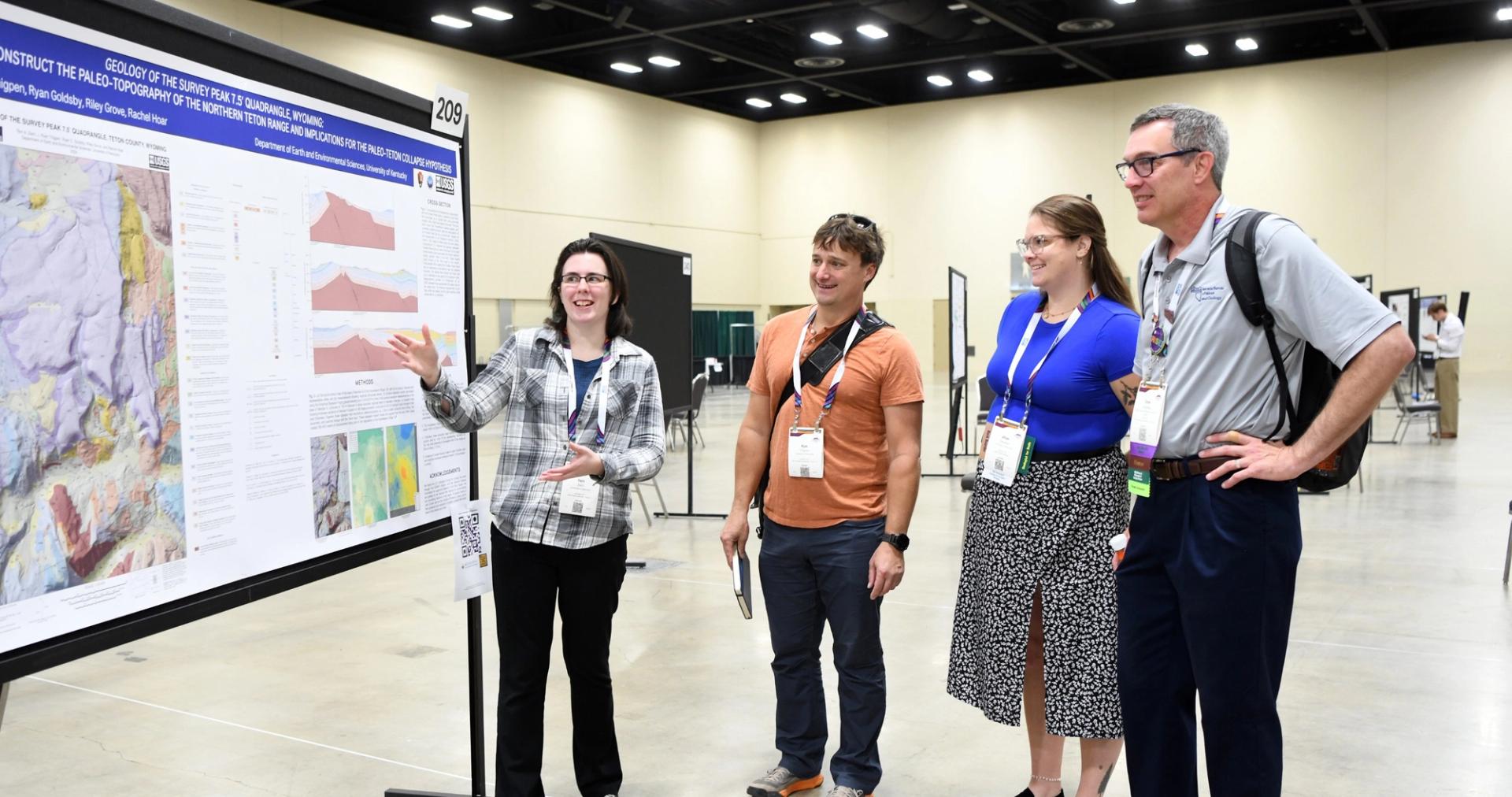 Connects 2025 attendee presenting their poster to other attendees.