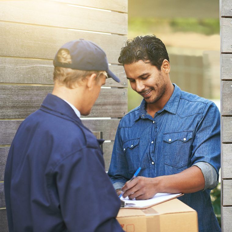 A recipient signing for a delivered parcel