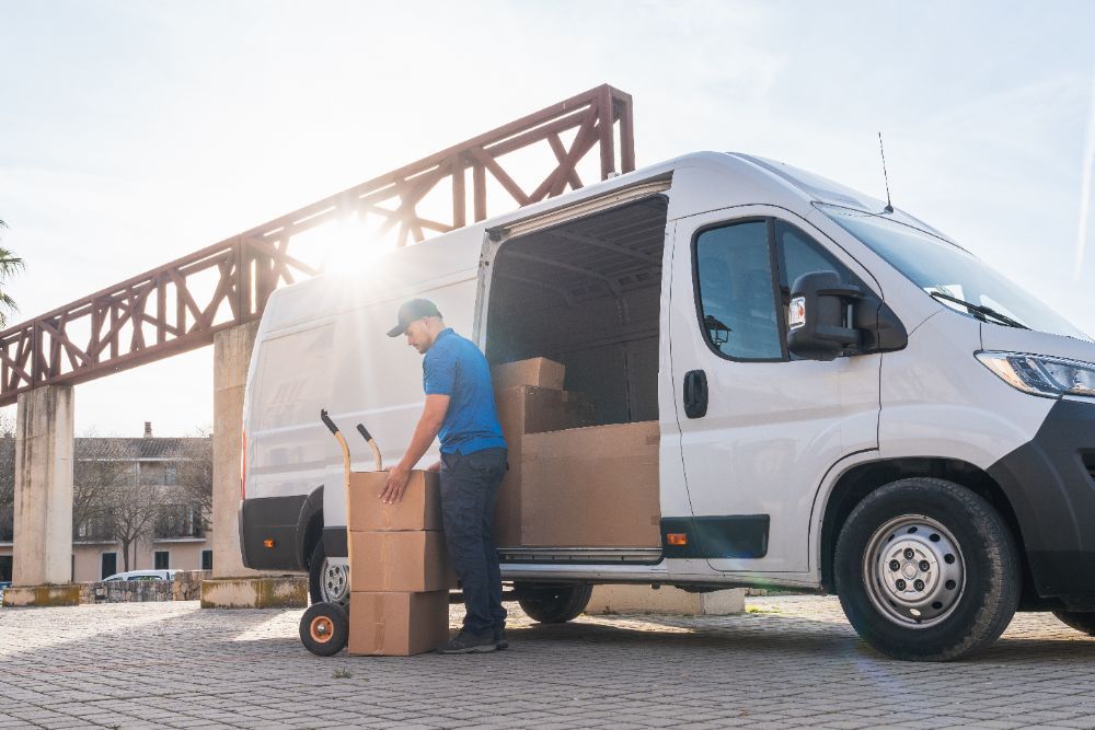 Courier unloading boxes from a van
